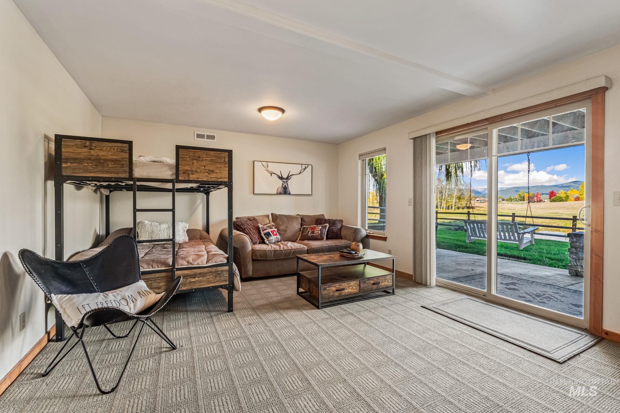 Carpeted living area featuring baseboards