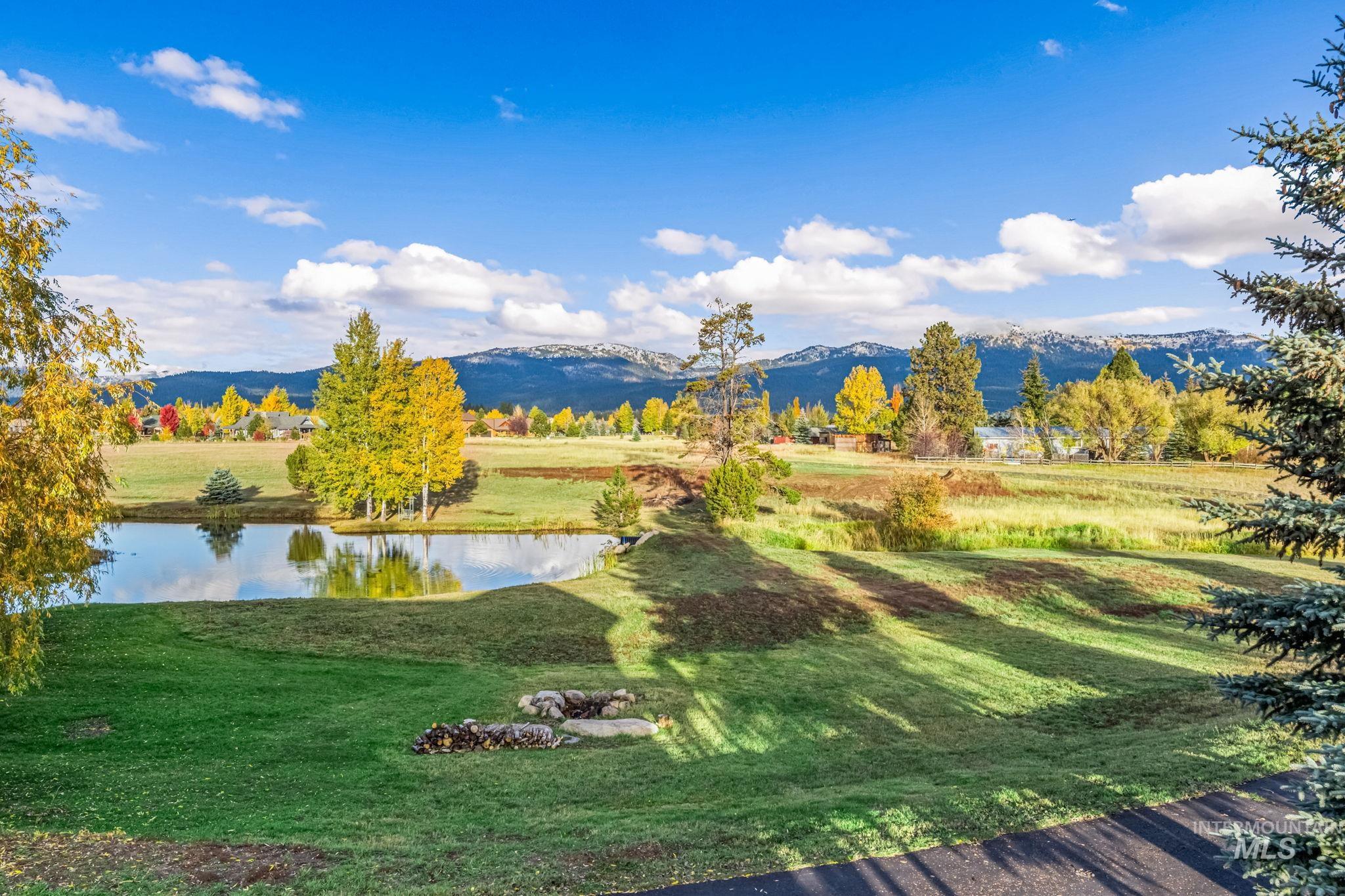 View of community featuring a water and mountain view and a yard