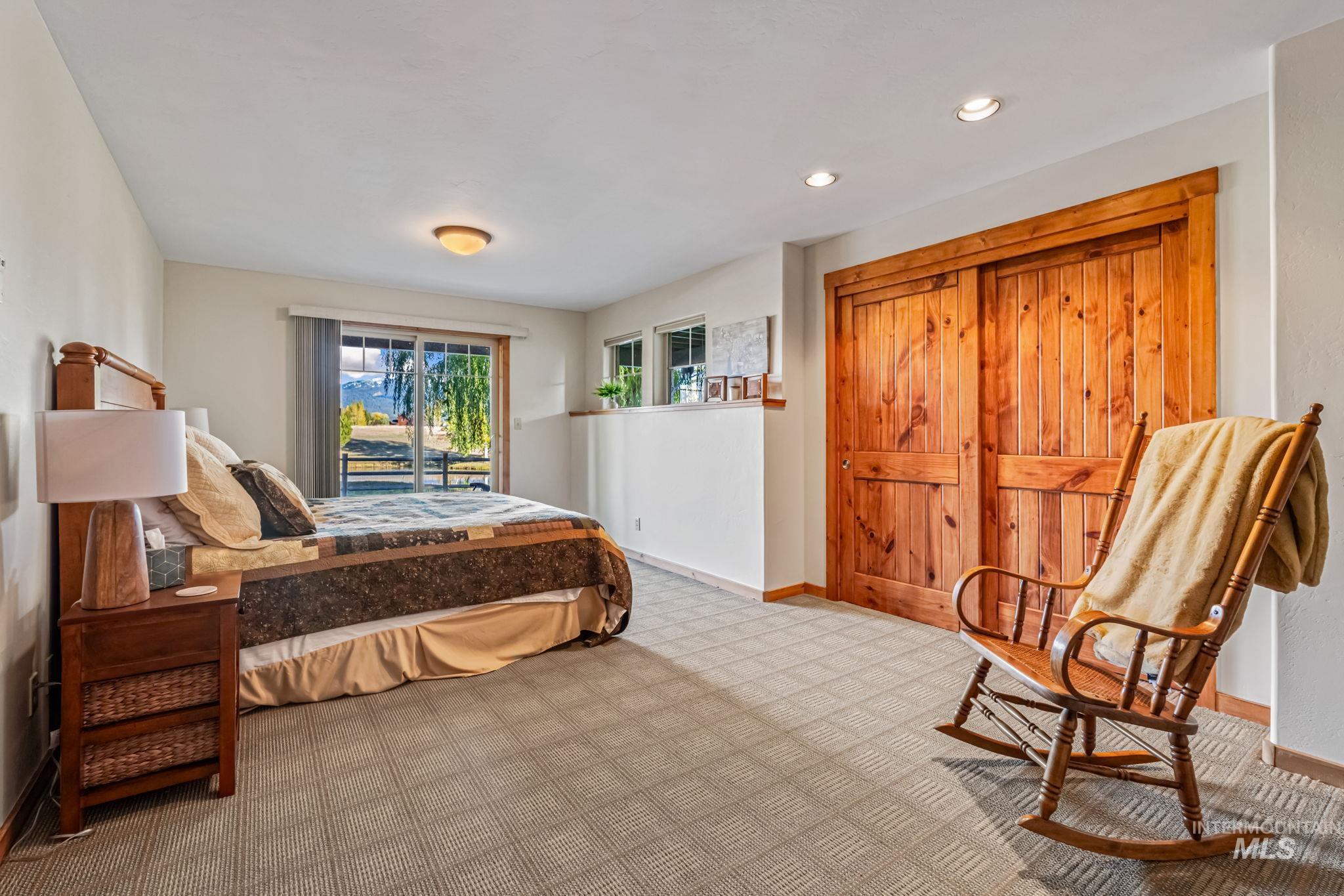 Carpeted bedroom featuring recessed lighting and a closet