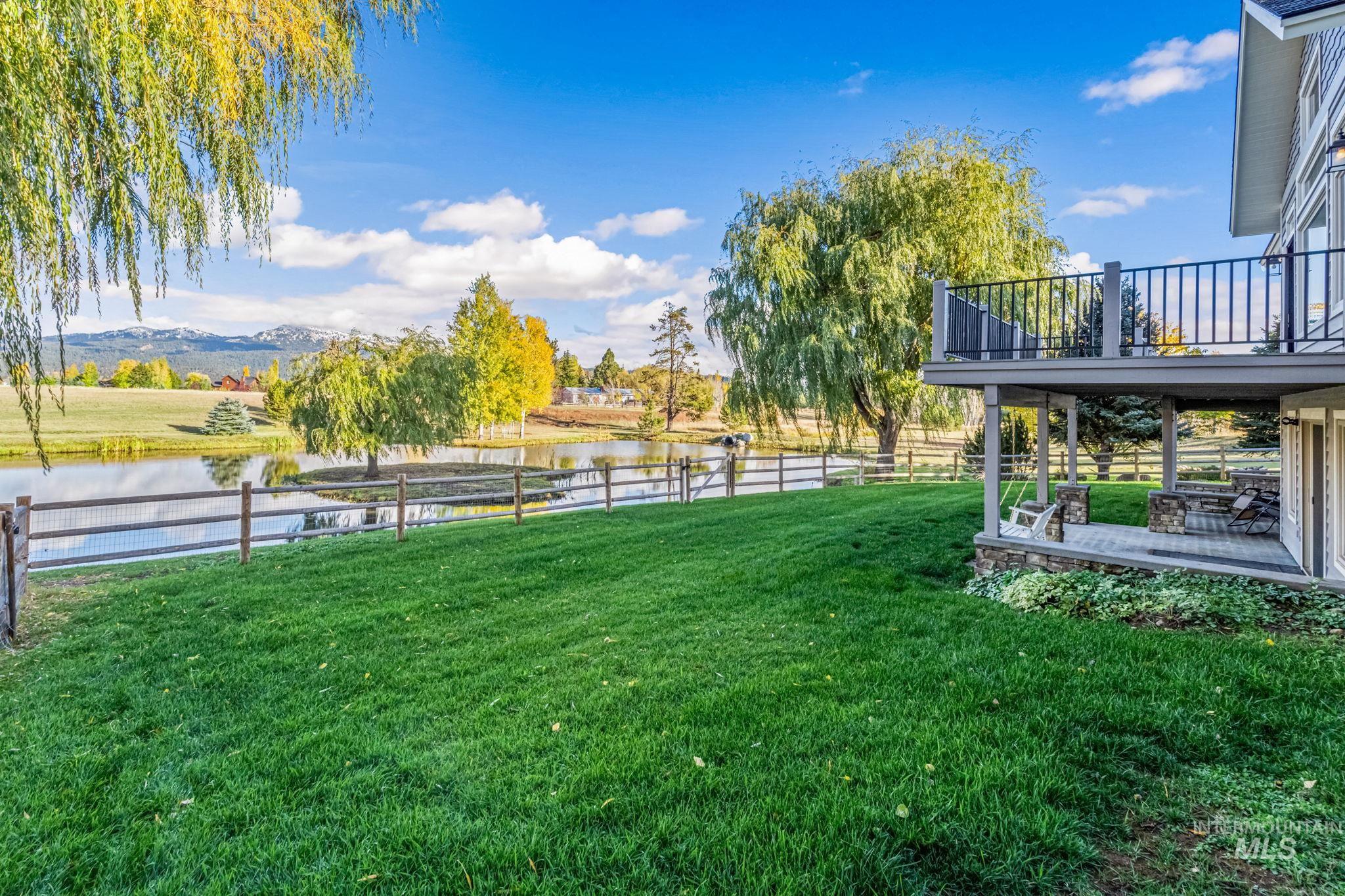 Fenced backyard with a patio area and a deck with water view
