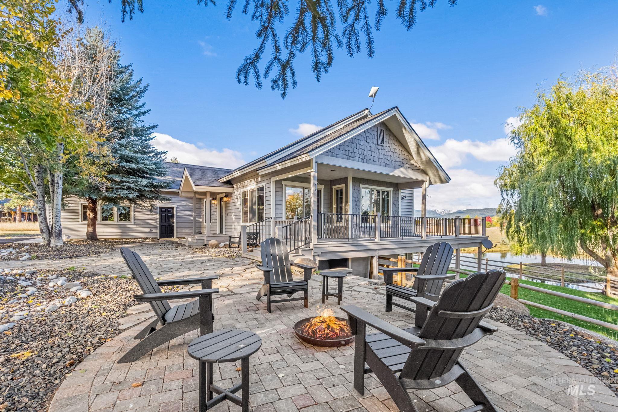 View of patio featuring an outdoor fire pit and a deck