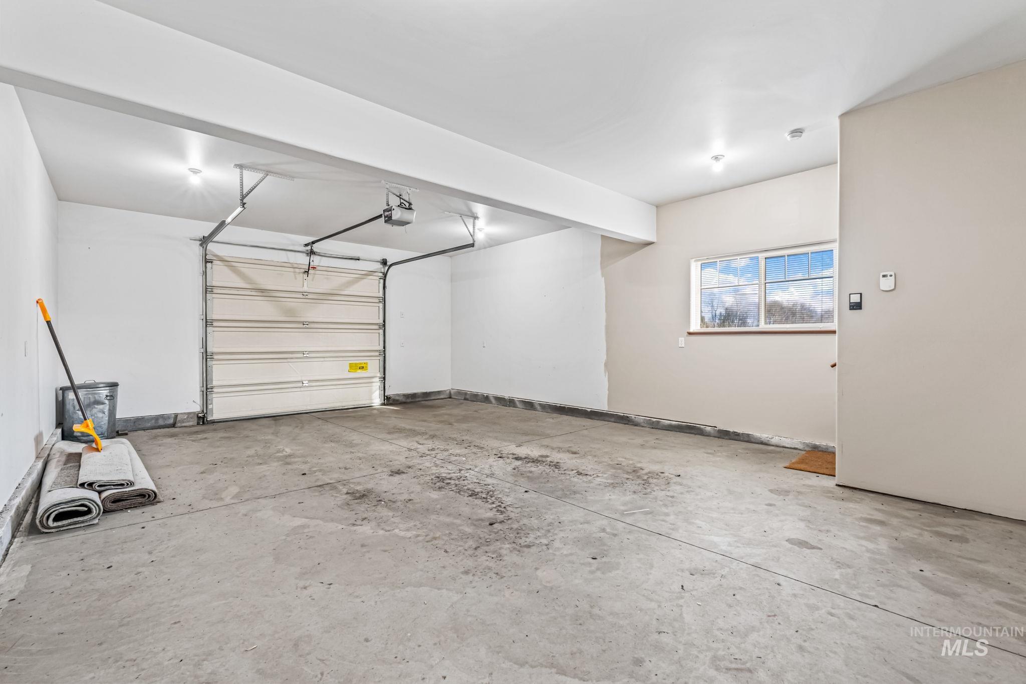 Garage featuring baseboards