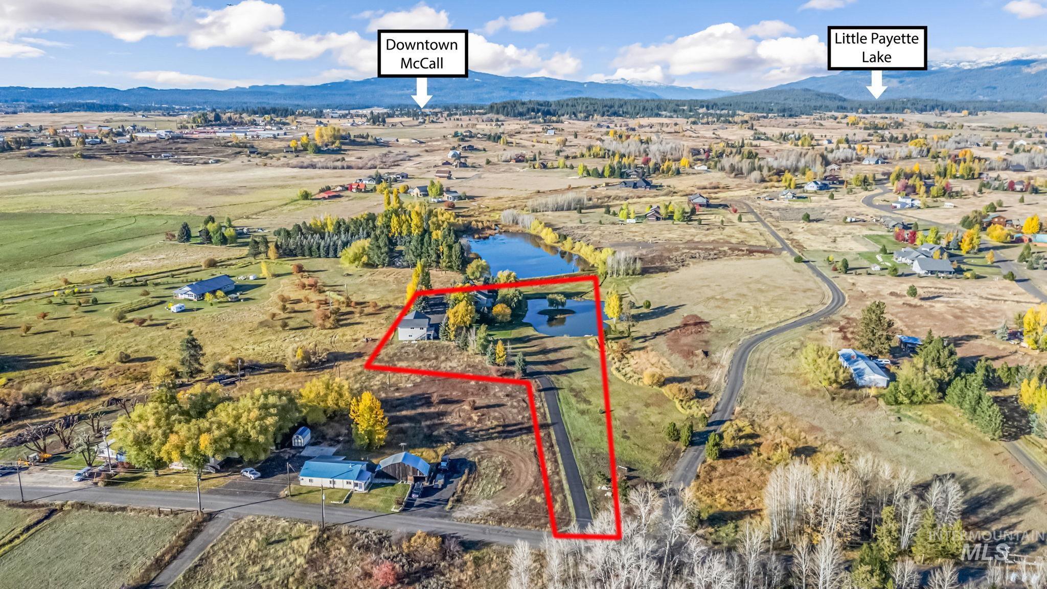 Overview of rural landscape with property boundaries highlighted and a mountain backdrop