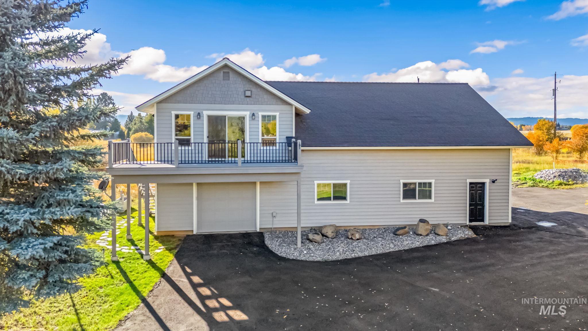 View of home's exterior with driveway, an attached garage, and roof with shingles