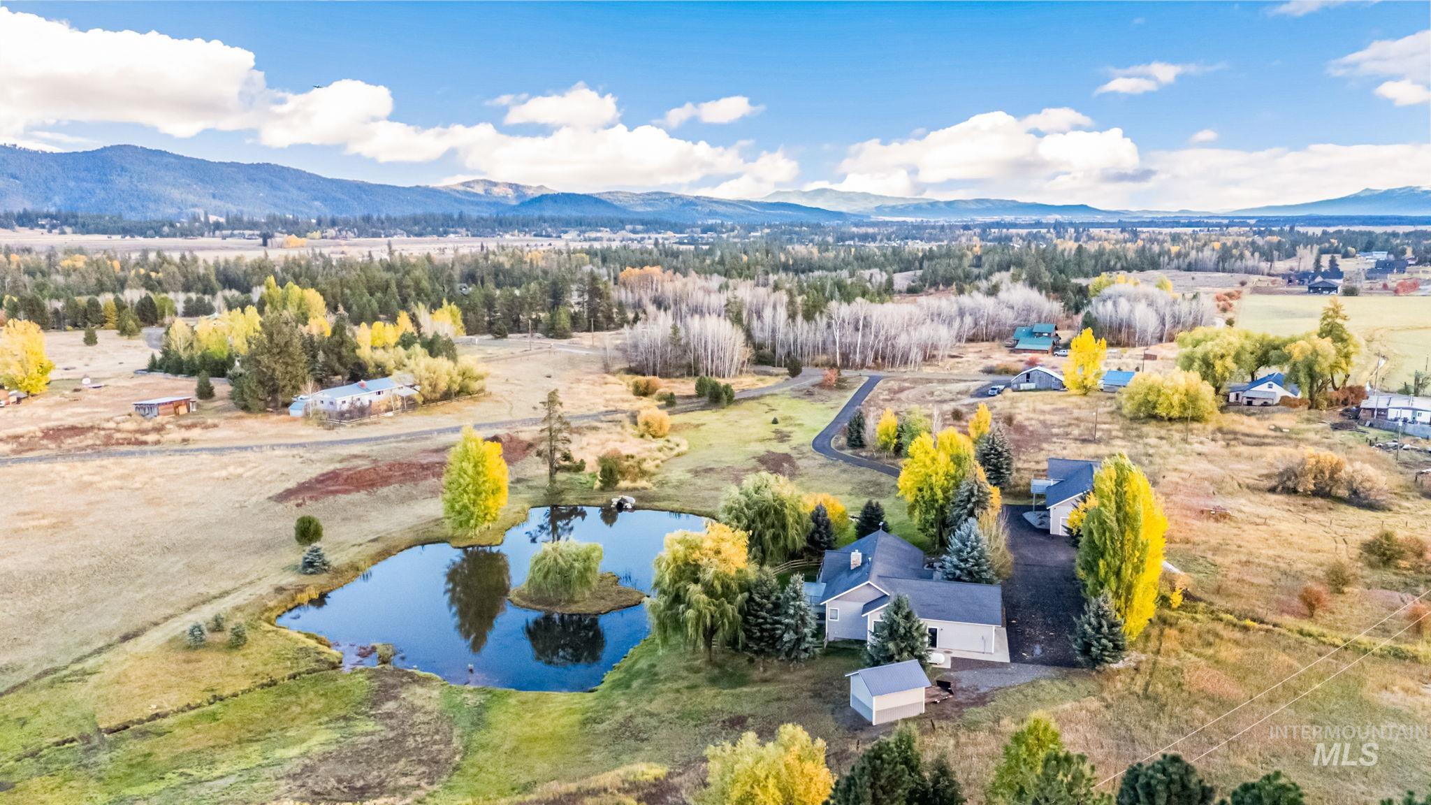 Aerial view of sparsely populated area featuring a water and mountain view