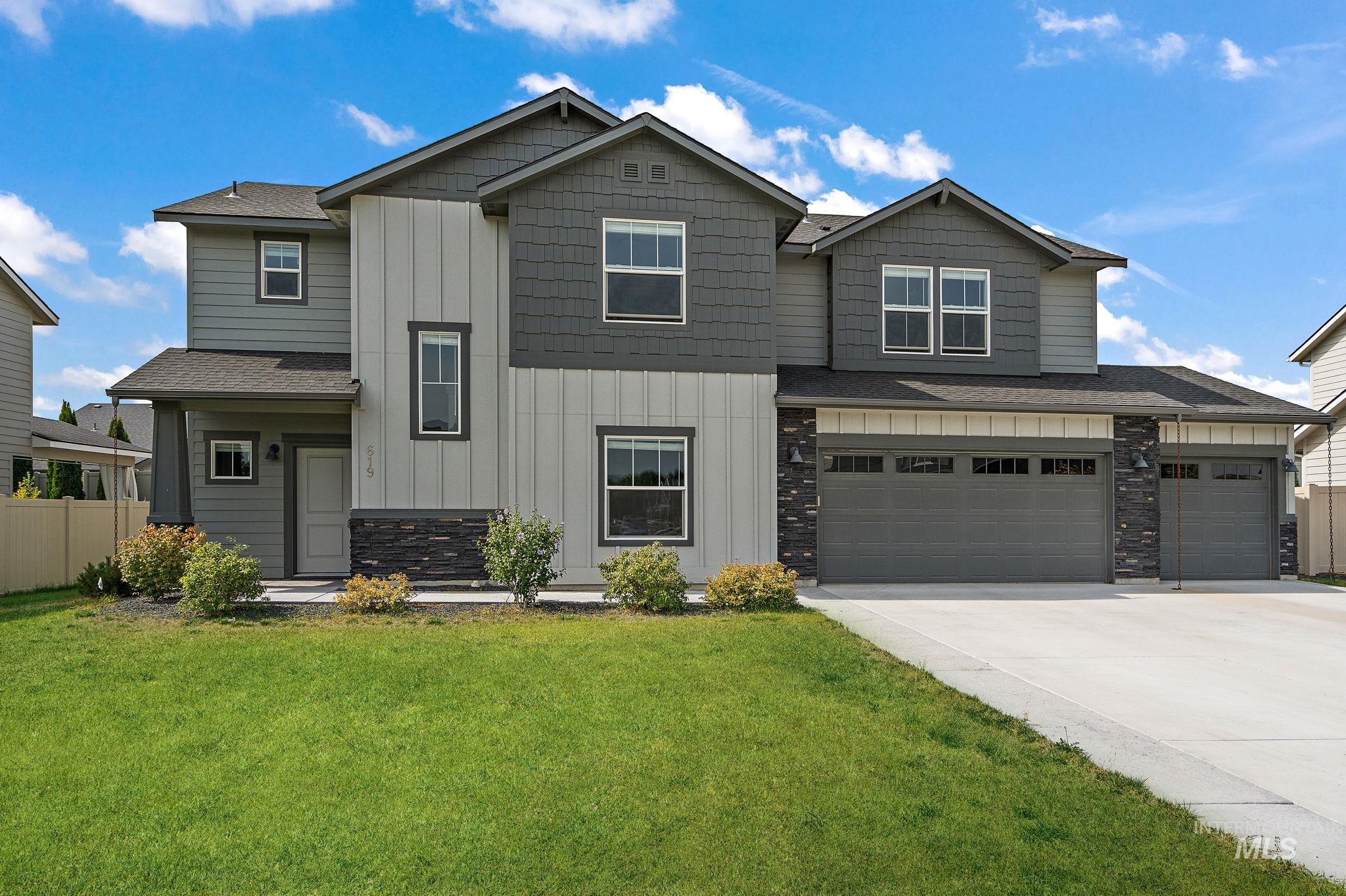 Craftsman house with board and batten siding, concrete driveway, stone siding, a garage, and a shingled roof