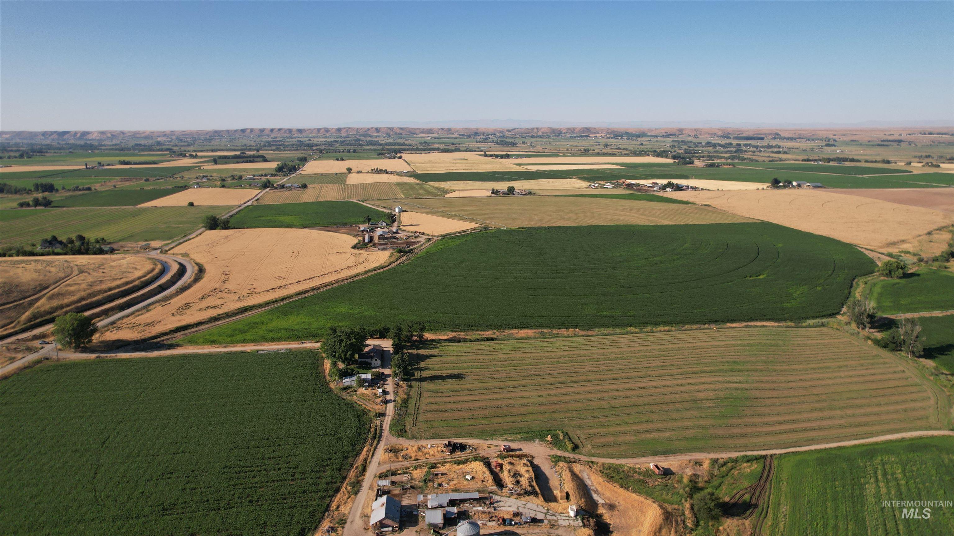 Aerial overview of property's location featuring rural landscape and rows of crops
