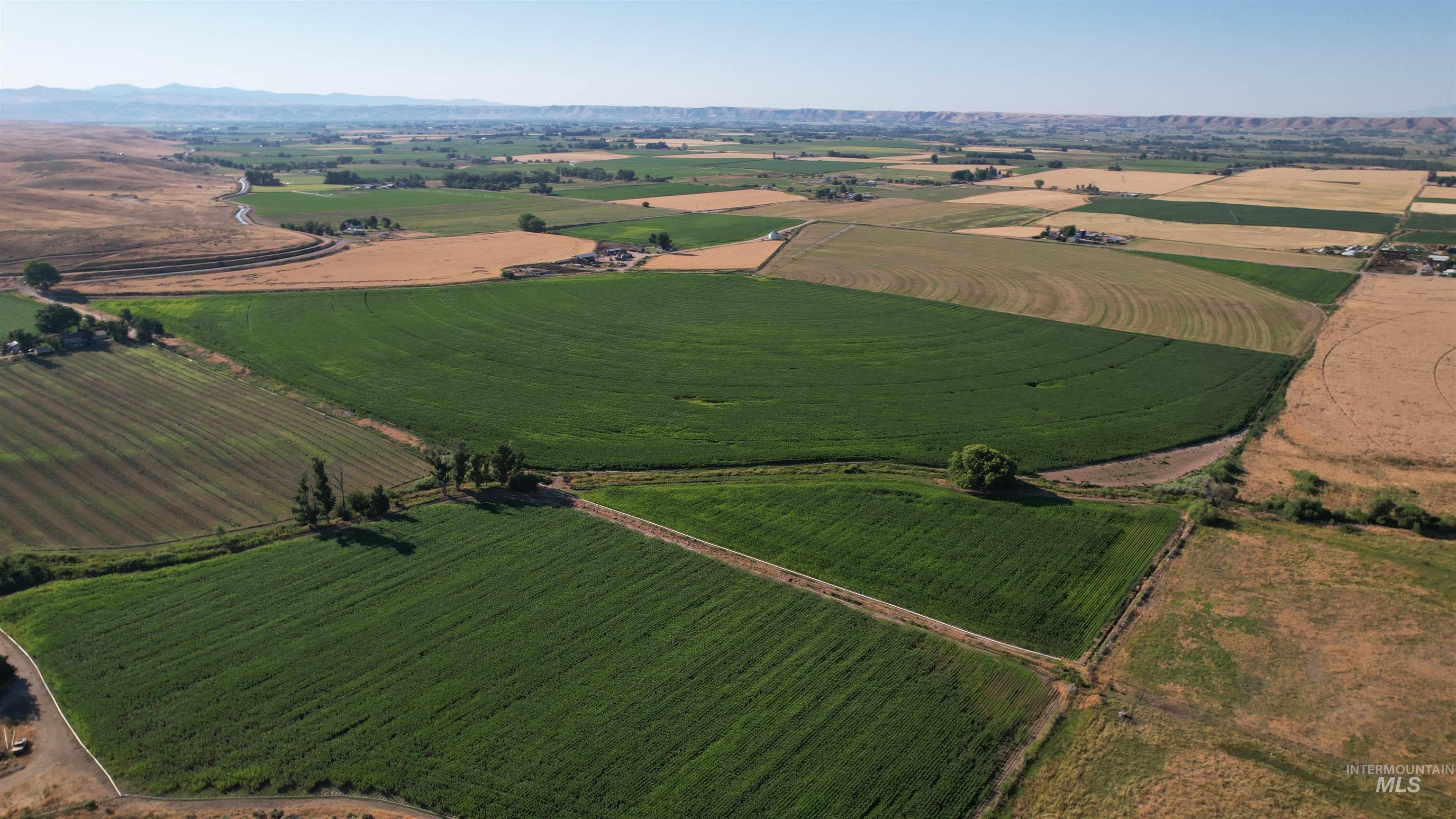 Aerial overview of property's location with rural landscape and rows of crops