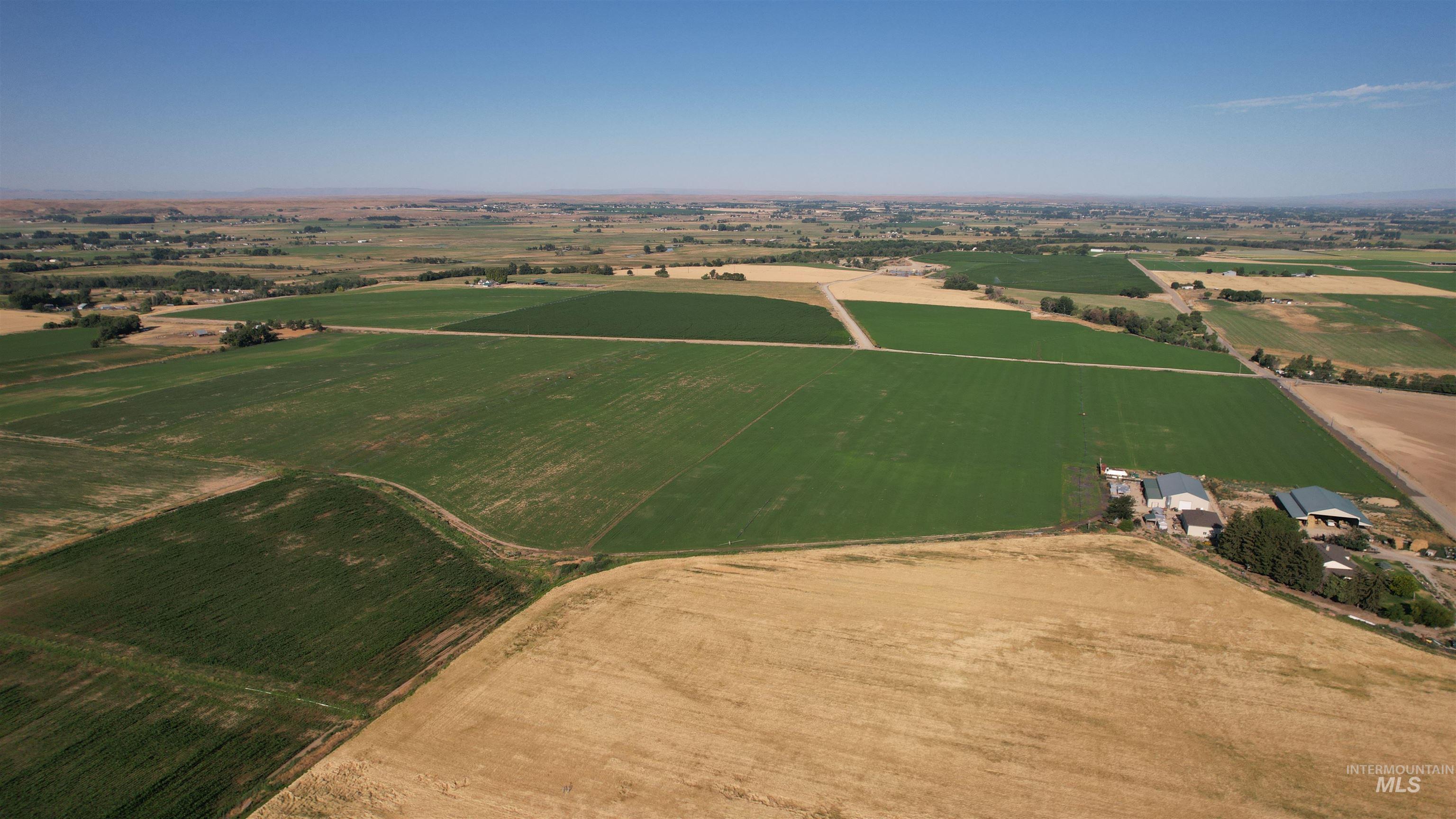 Aerial view of property's location featuring rural landscape and extensive farmland