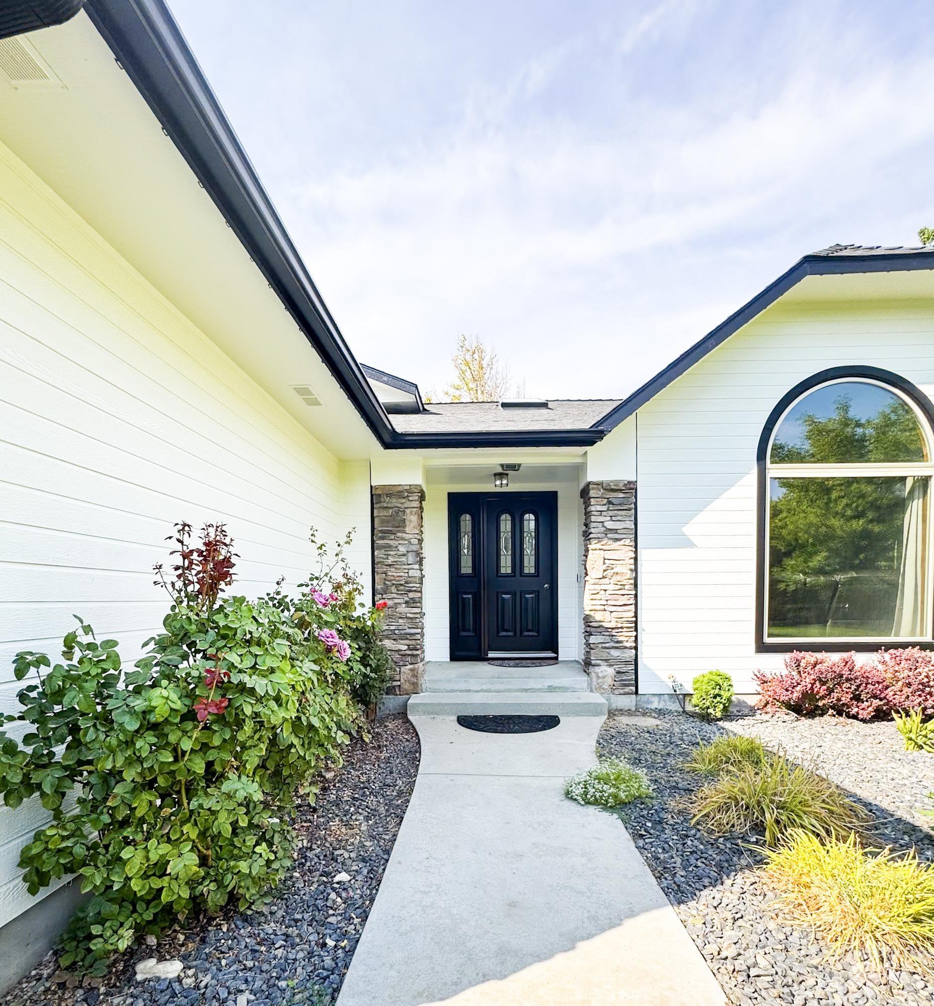Entrance to property featuring stone siding