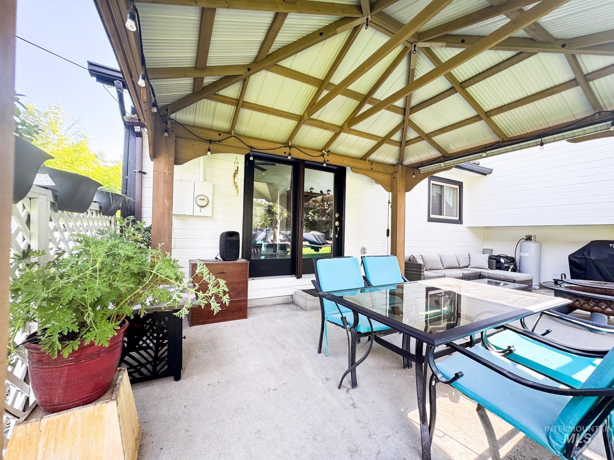 View of patio with outdoor dining space and a gazebo