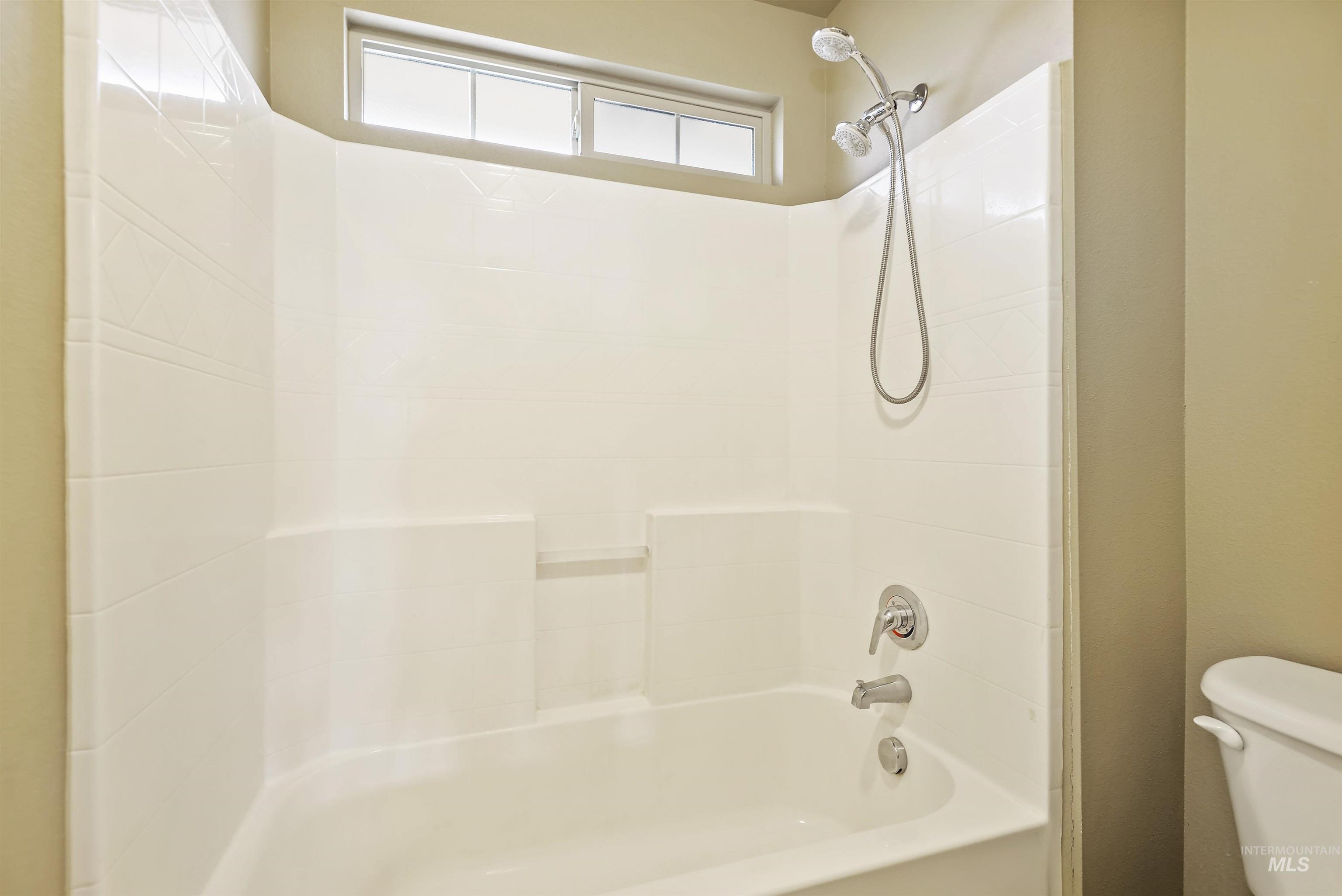 Full bath with tub / shower combination and toilet