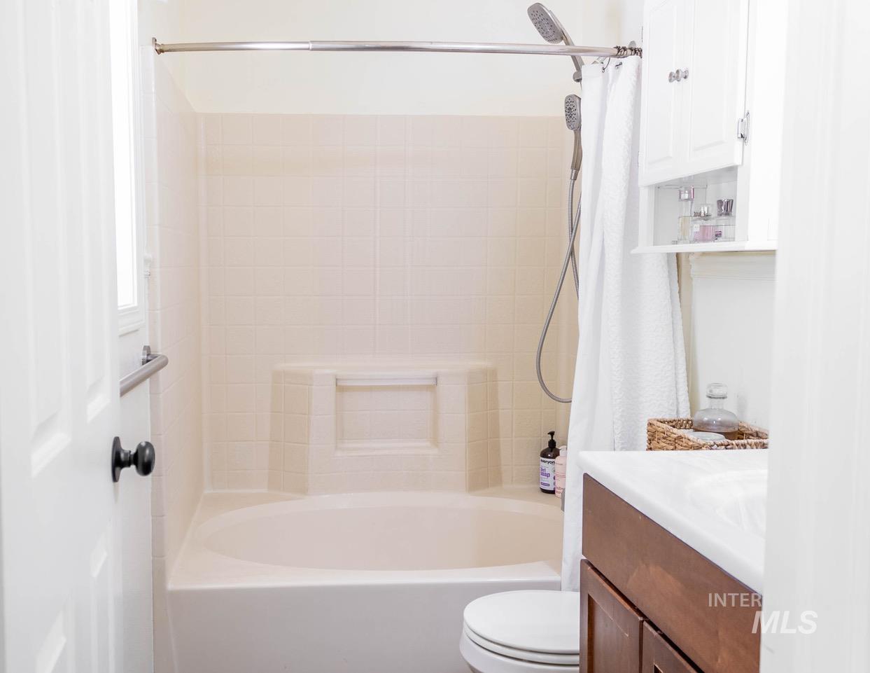 Full bathroom with vanity and shower / tub combo