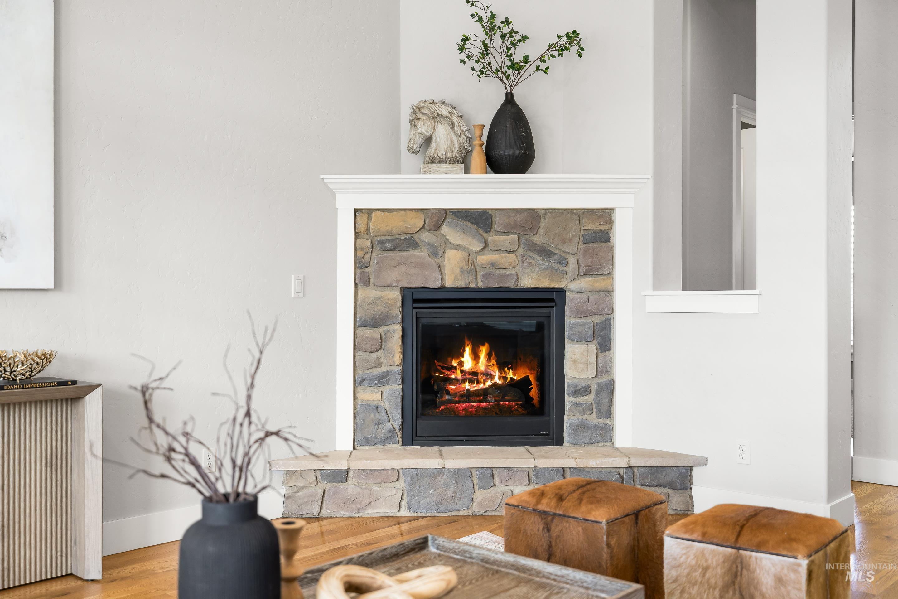 Detailed view of wood finished floors and a fireplace
