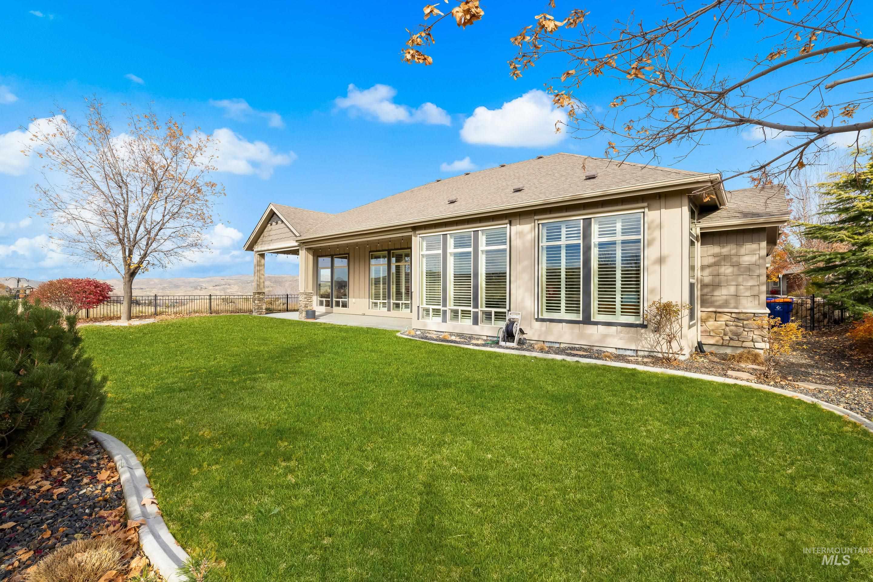 Back of house with roof with shingles, a patio area, and board and batten siding