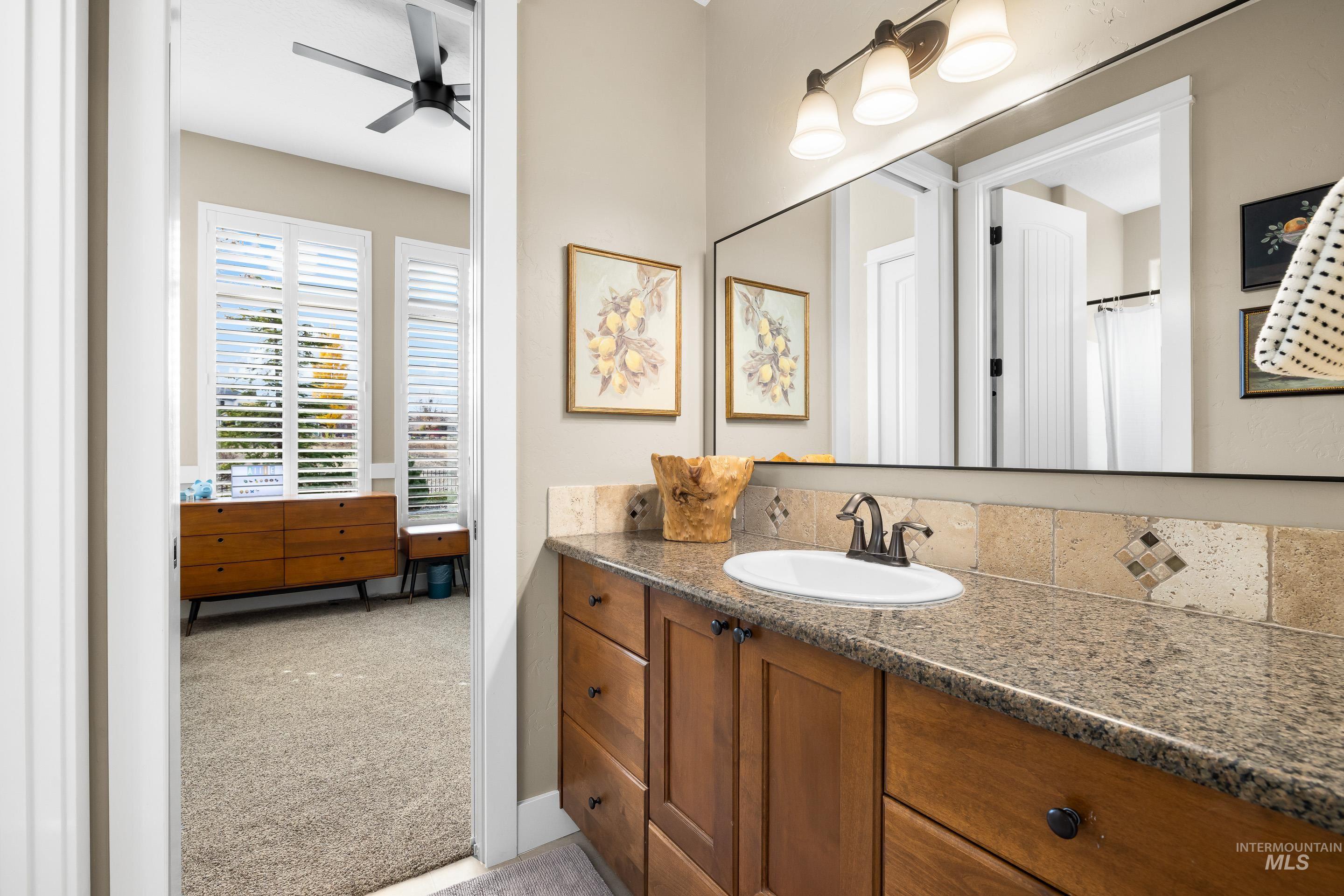 Full bathroom featuring light colored carpet, vanity, and ceiling fan