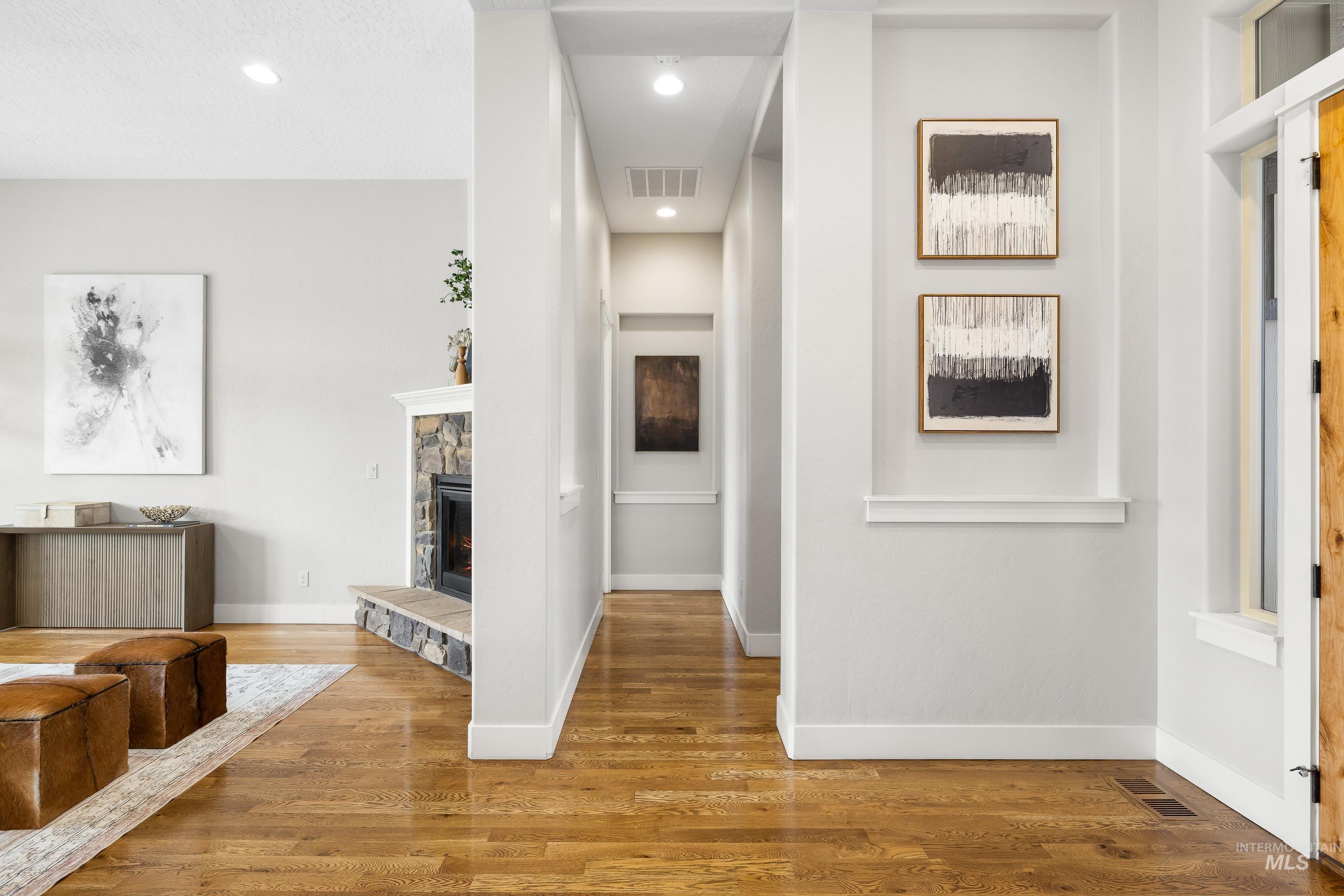 Corridor featuring wood finished floors and recessed lighting