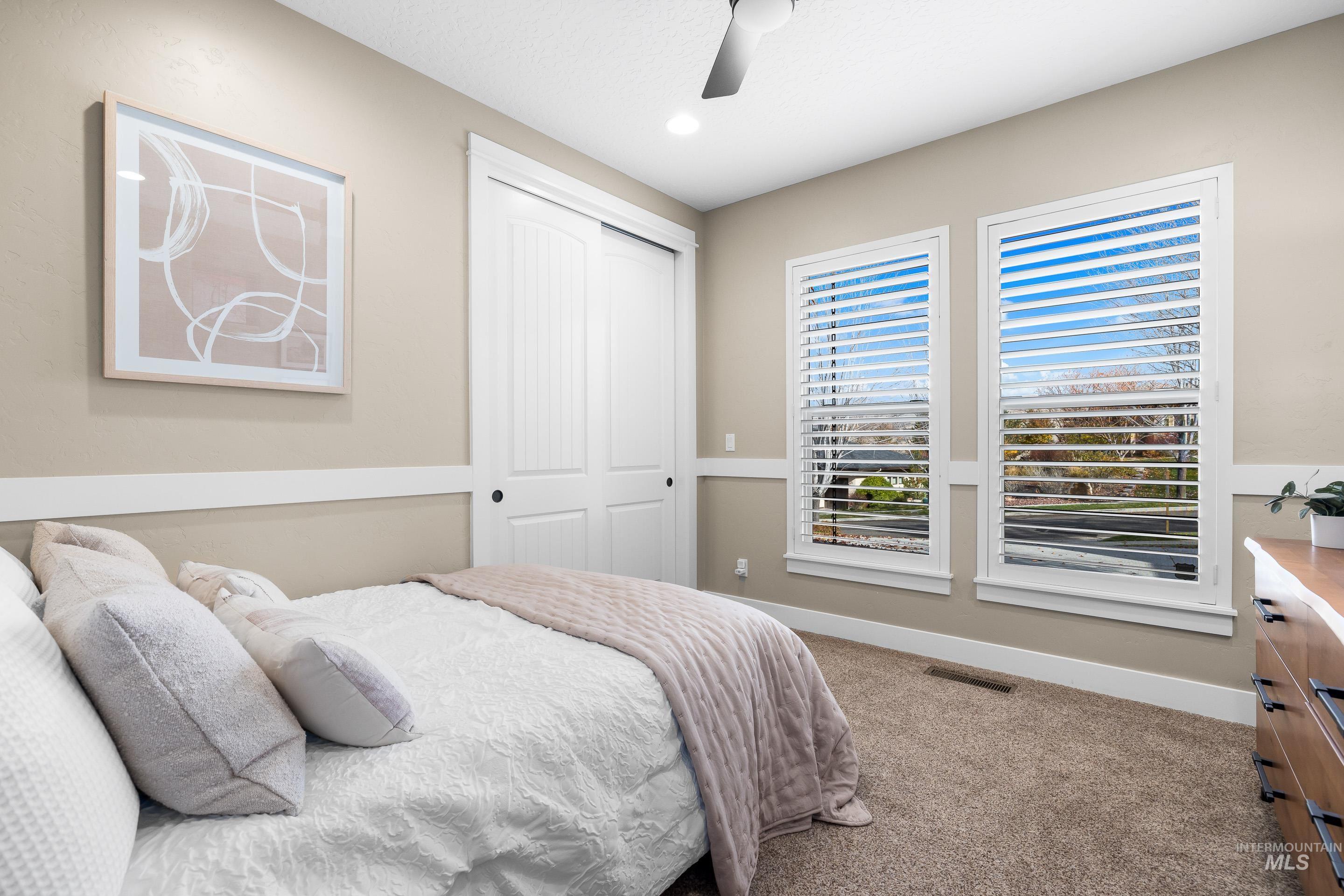 Bedroom with carpet, ceiling fan, a closet, and recessed lighting