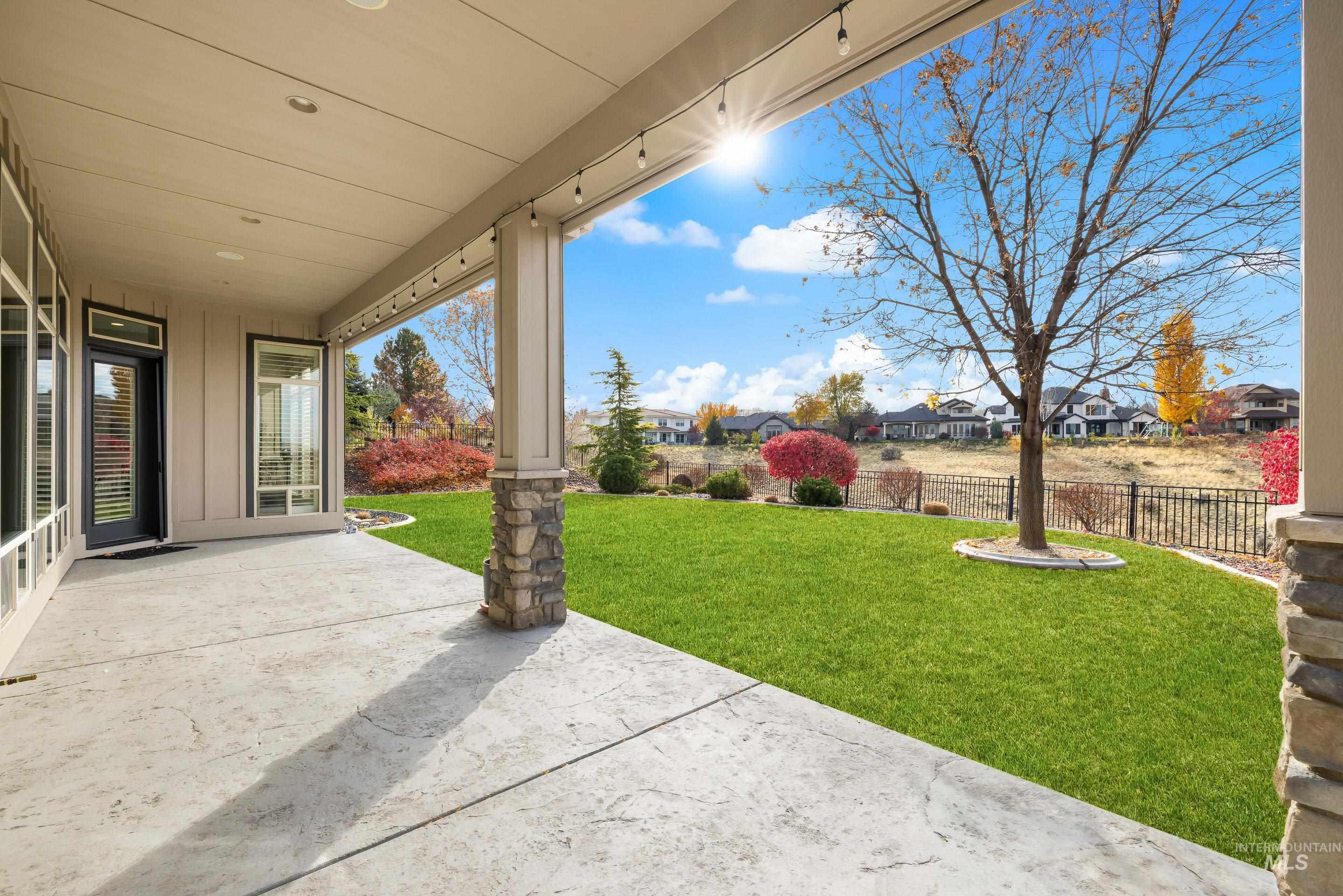Fenced backyard featuring a patio area and a residential view