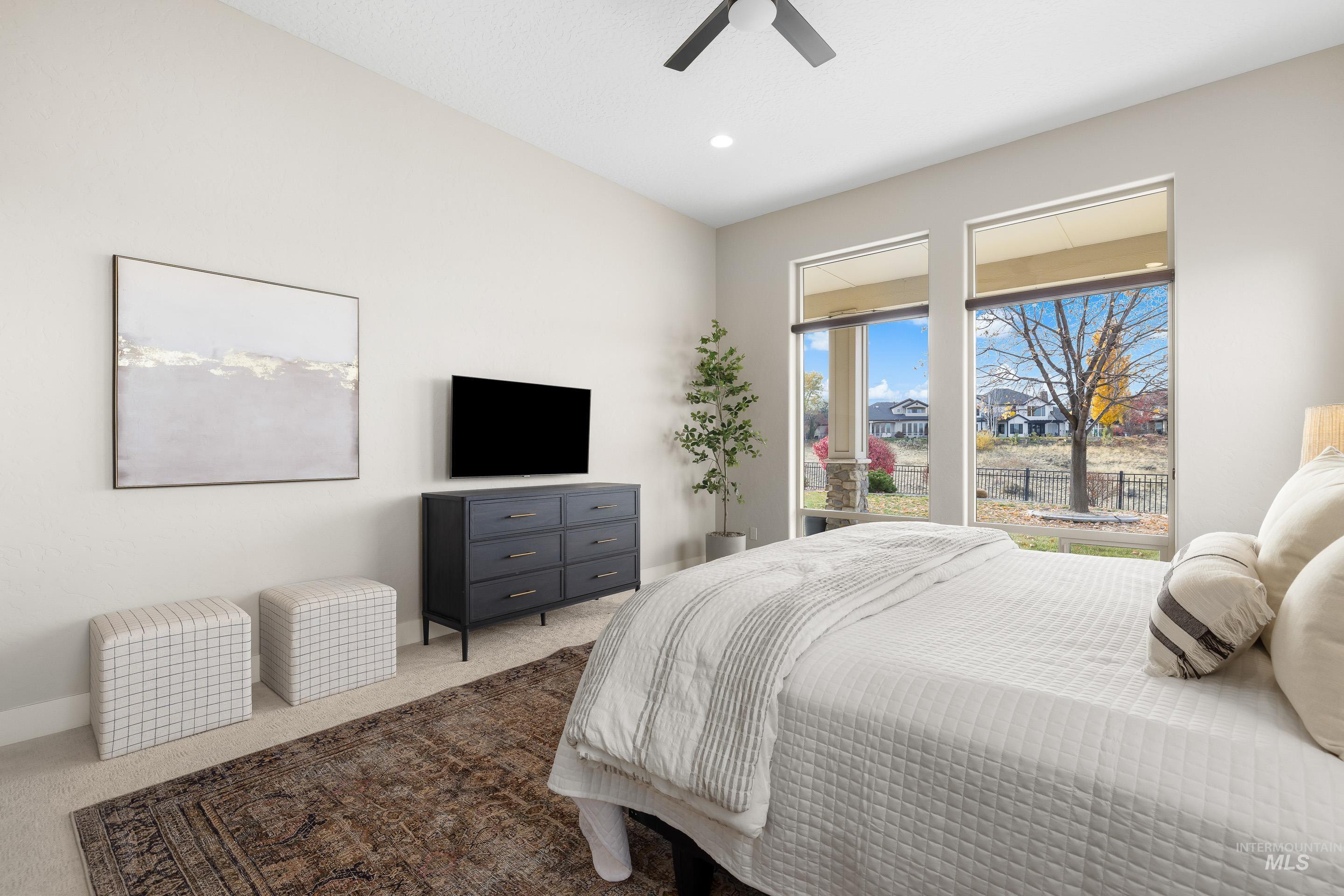 Bedroom with carpet floors, ceiling fan, and recessed lighting