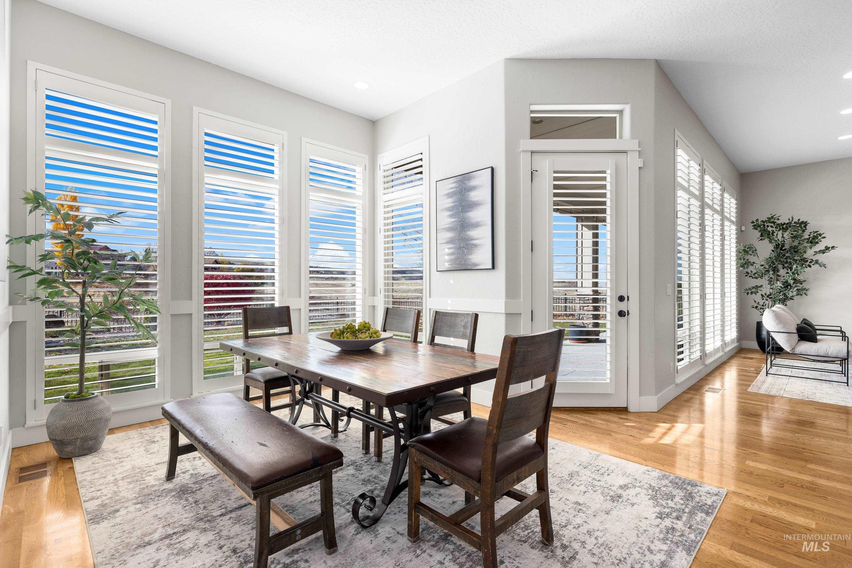 Dining space with light wood-type flooring and recessed lighting