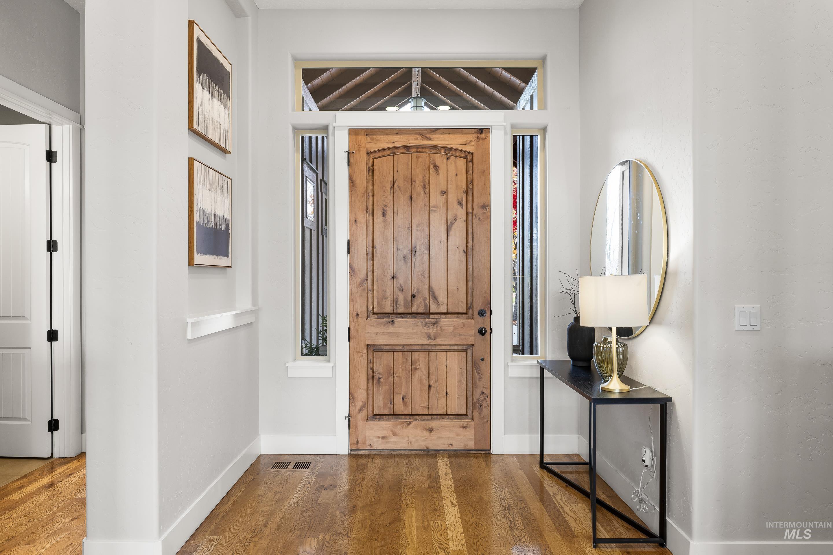 Entrance foyer featuring wood finished floors and baseboards
