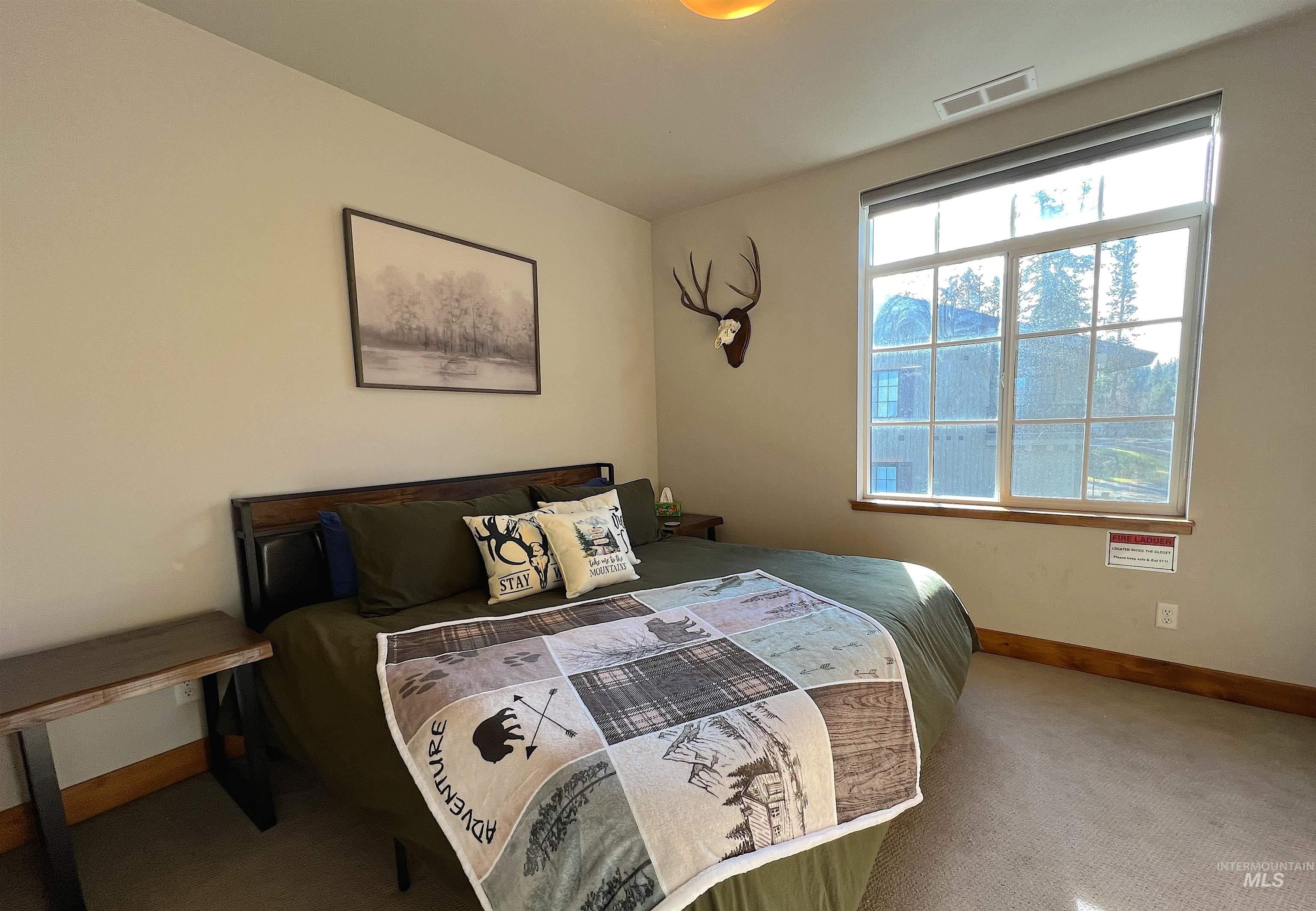 Bedroom with carpet floors and baseboards
