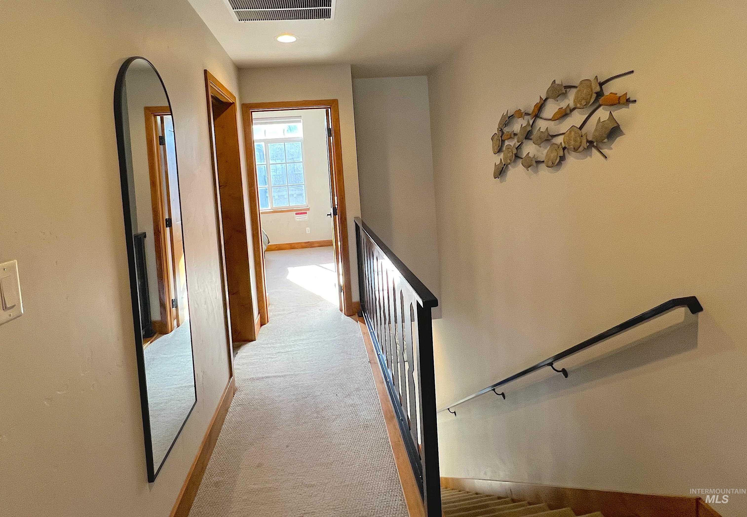 Corridor with light carpet, an upstairs landing, and recessed lighting