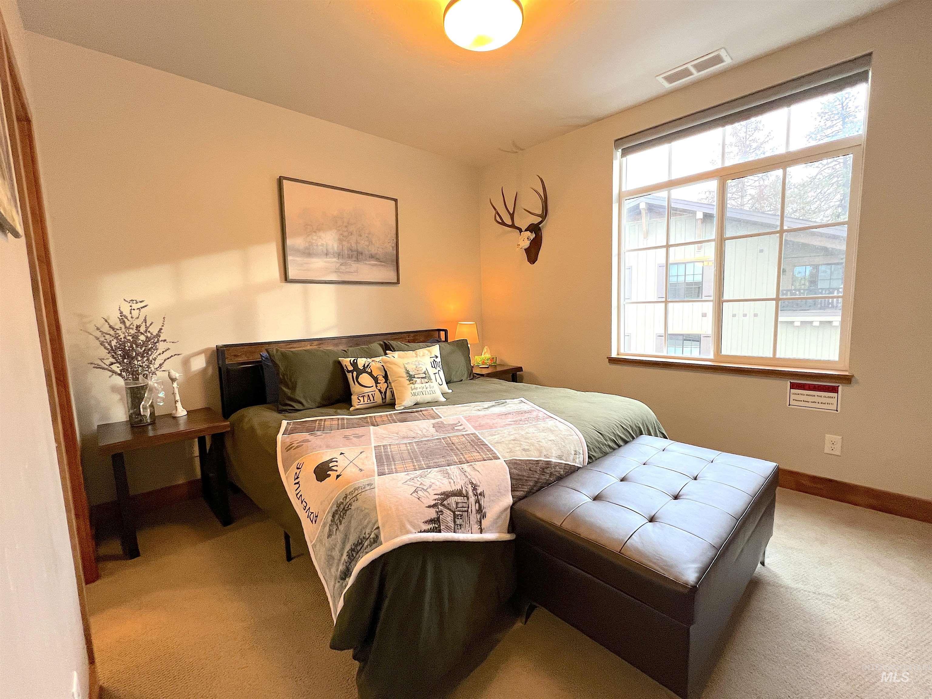 Bedroom featuring carpet flooring and baseboards