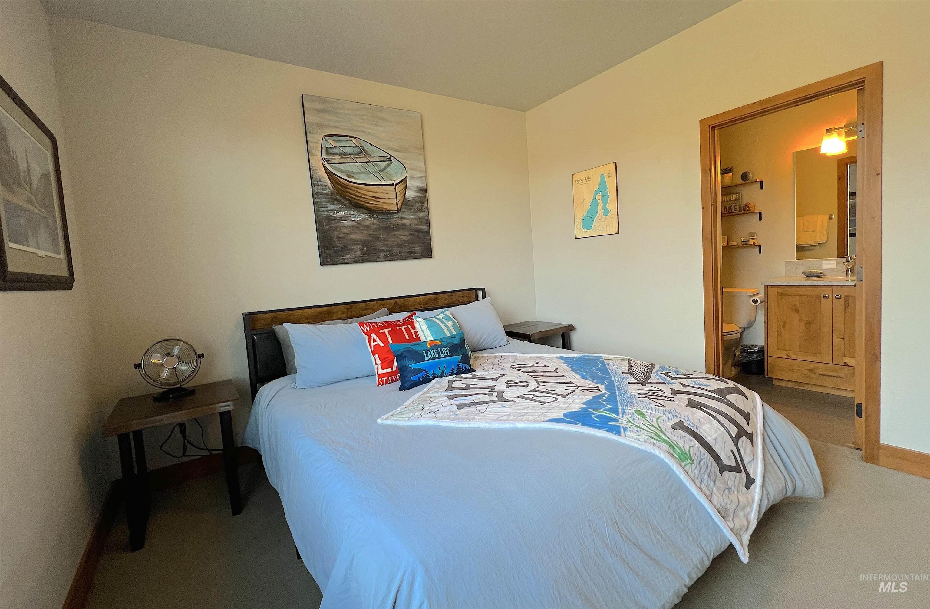 Bedroom with connected bathroom and carpet