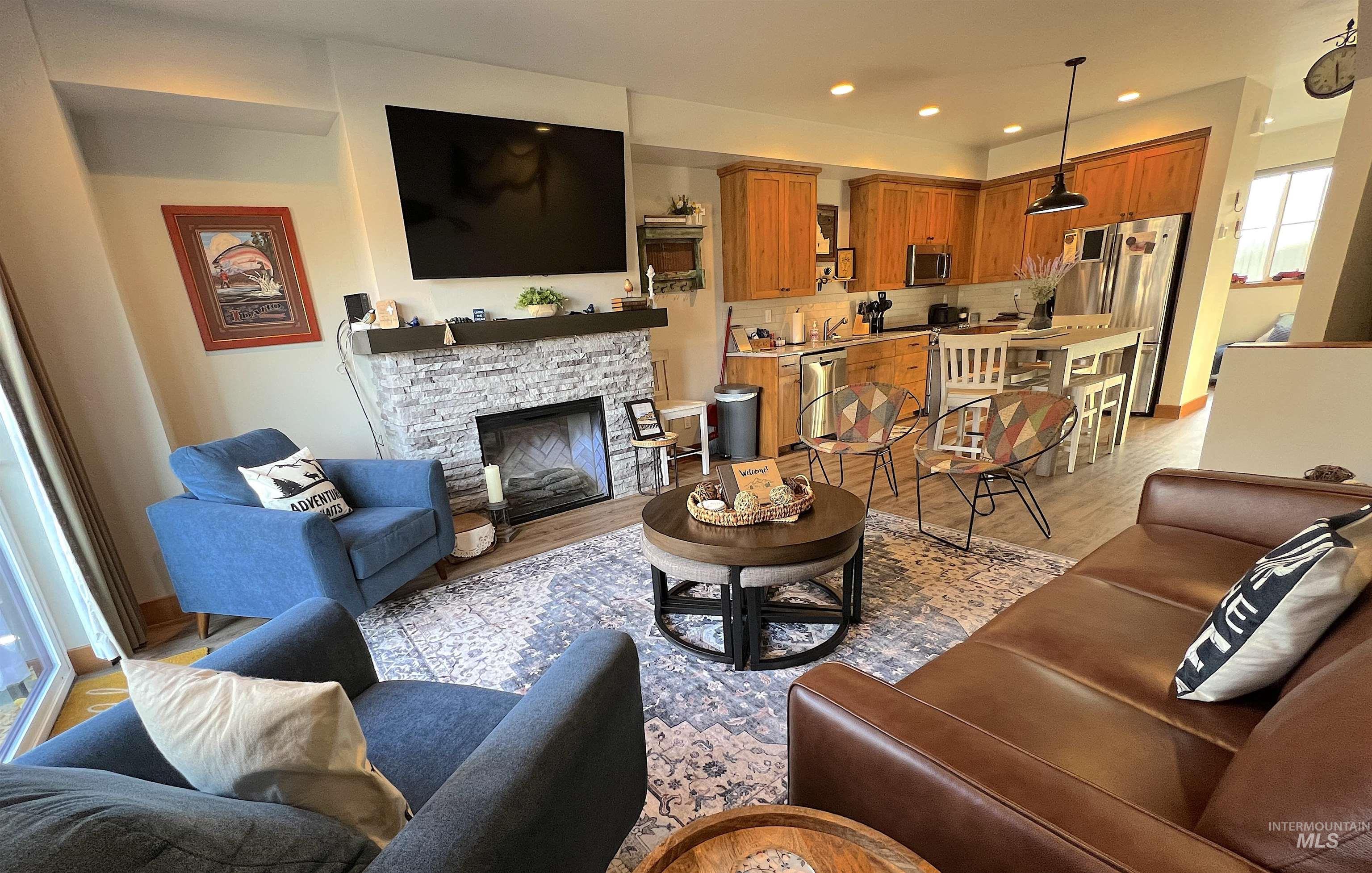 Living area with a fireplace, recessed lighting, and light wood finished floors