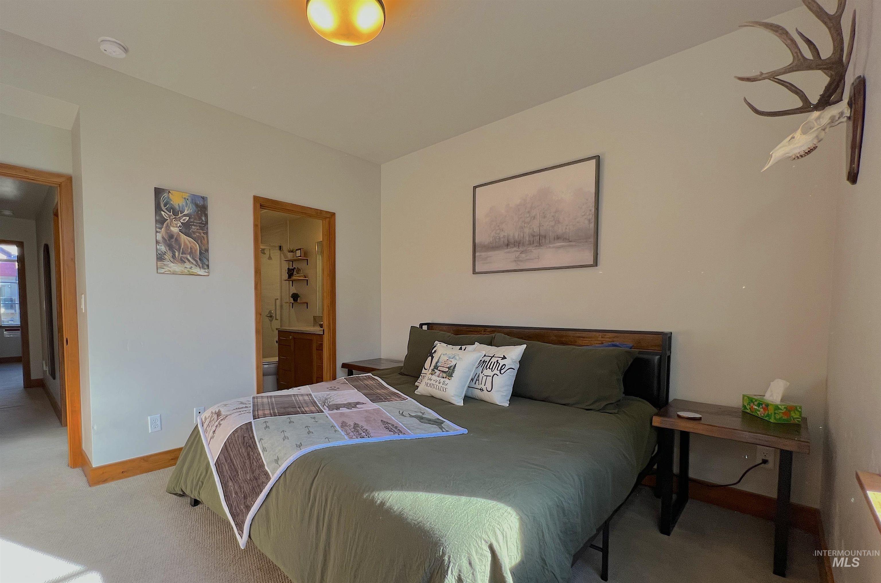 Bedroom featuring carpet floors and ensuite bath