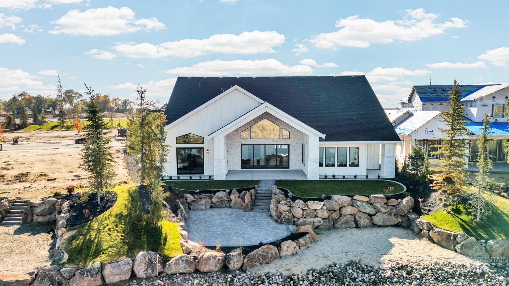 Rear view of house featuring a small pond