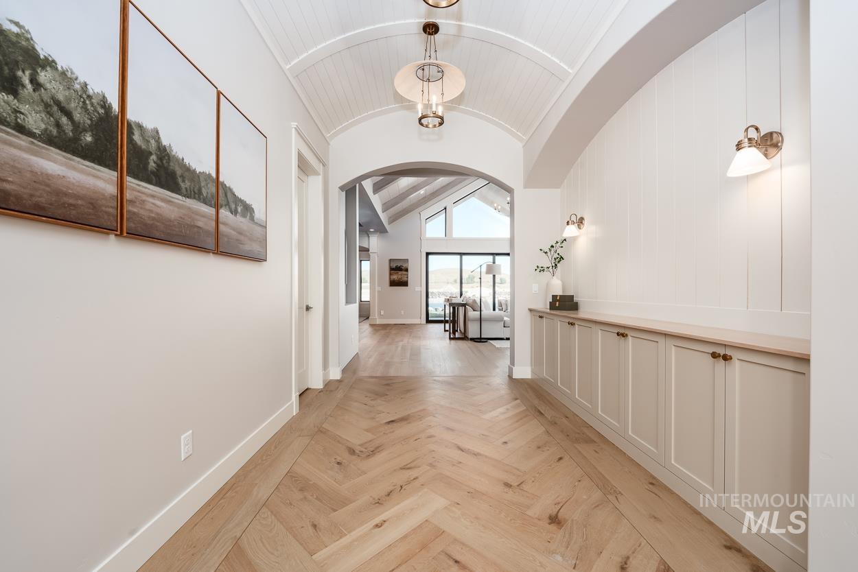 Hallway with vaulted ceiling and arched walkways
