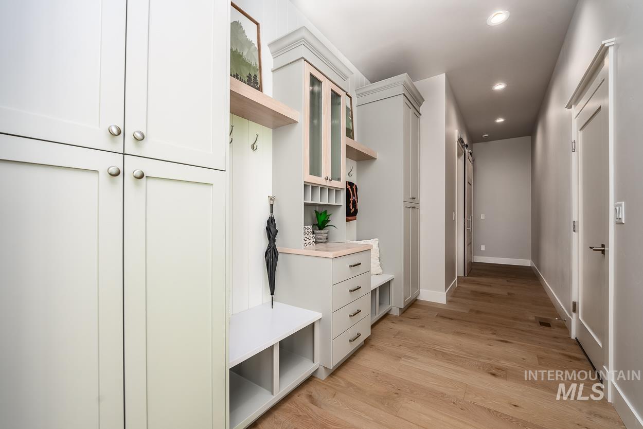 Mudroom with light wood-style flooring and recessed lighting