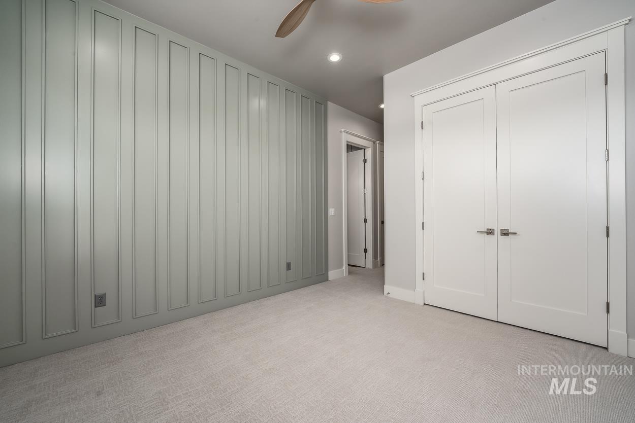 Unfurnished bedroom with light carpet, recessed lighting, ceiling fan, and a closet