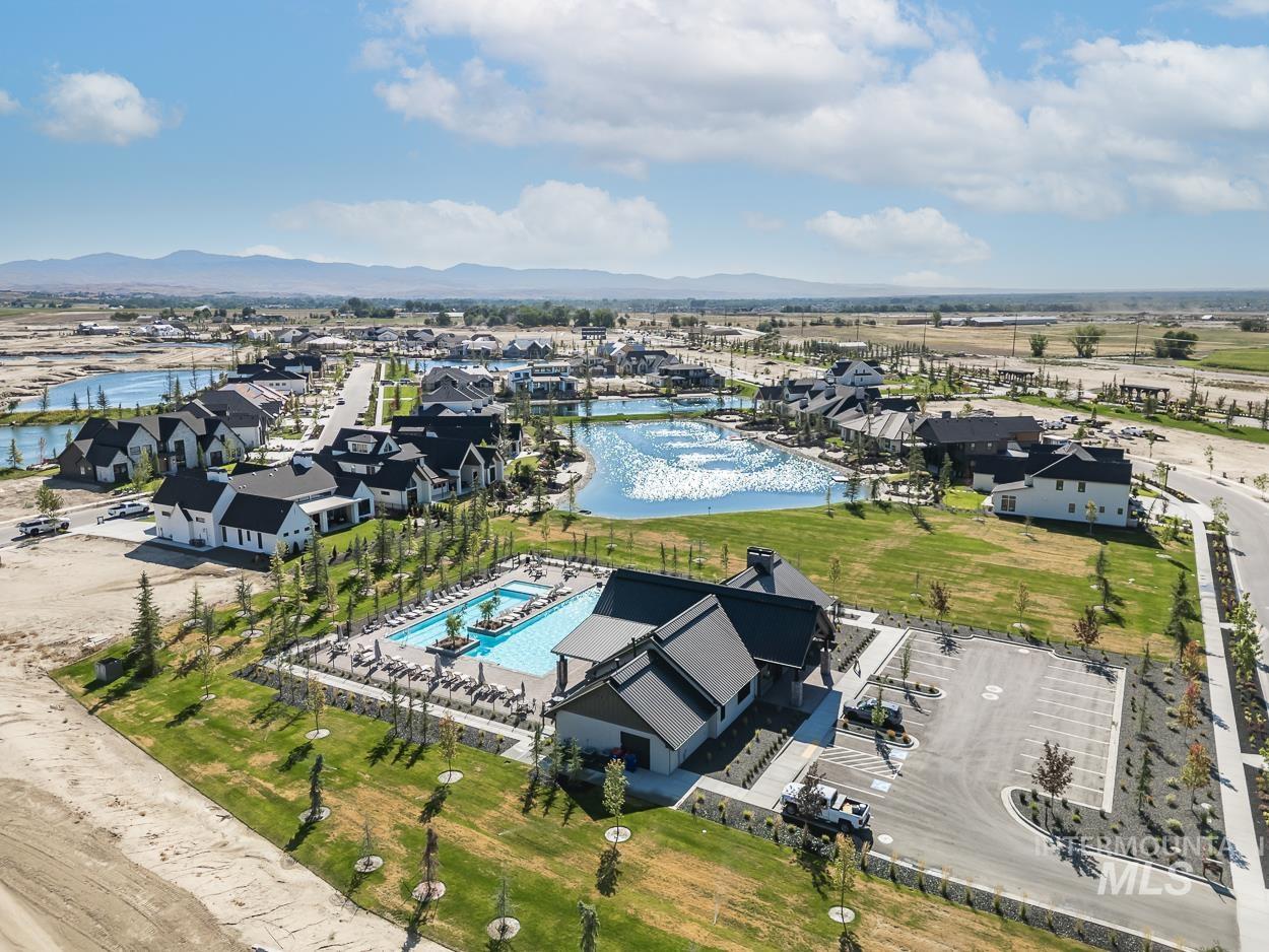 View of property location featuring a water and mountain view and nearby suburban area