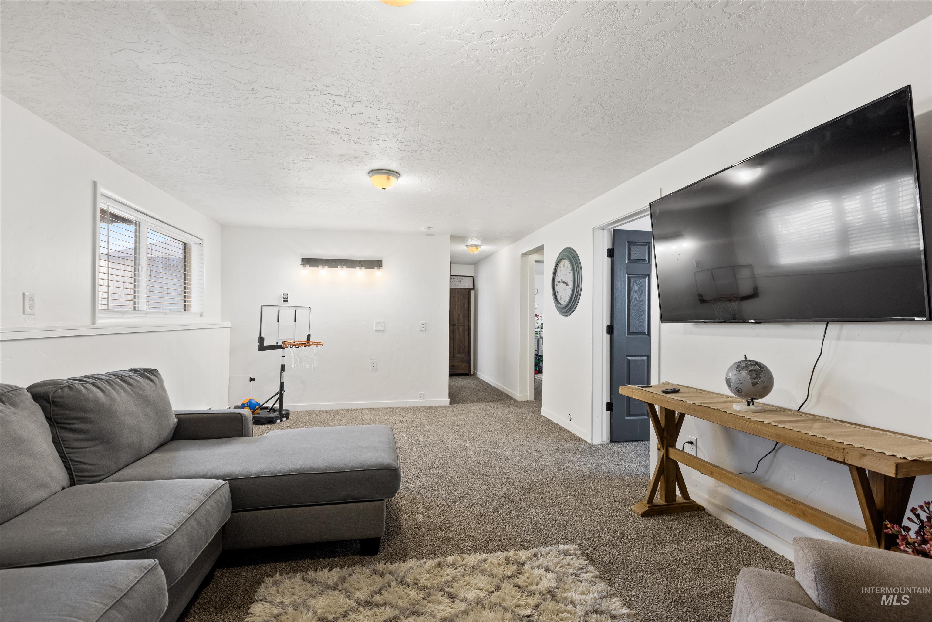 Living room with a textured ceiling and carpet