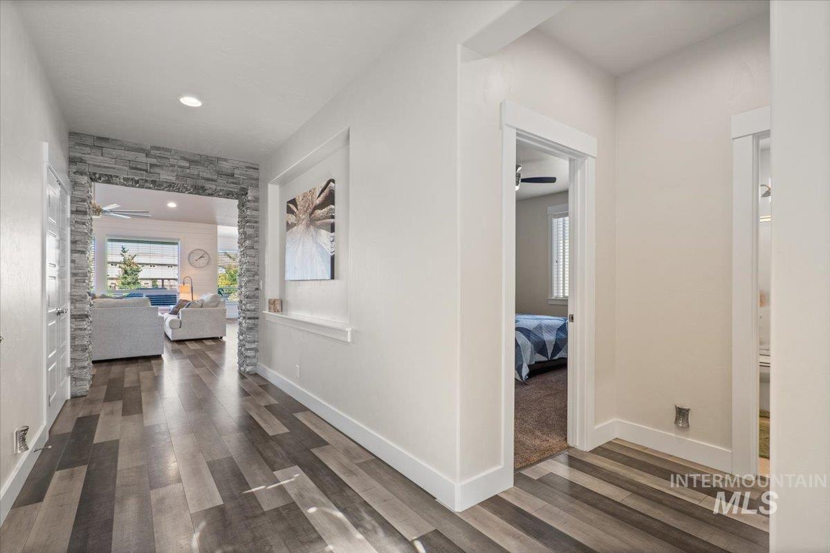 Hall featuring dark wood-style flooring and recessed lighting