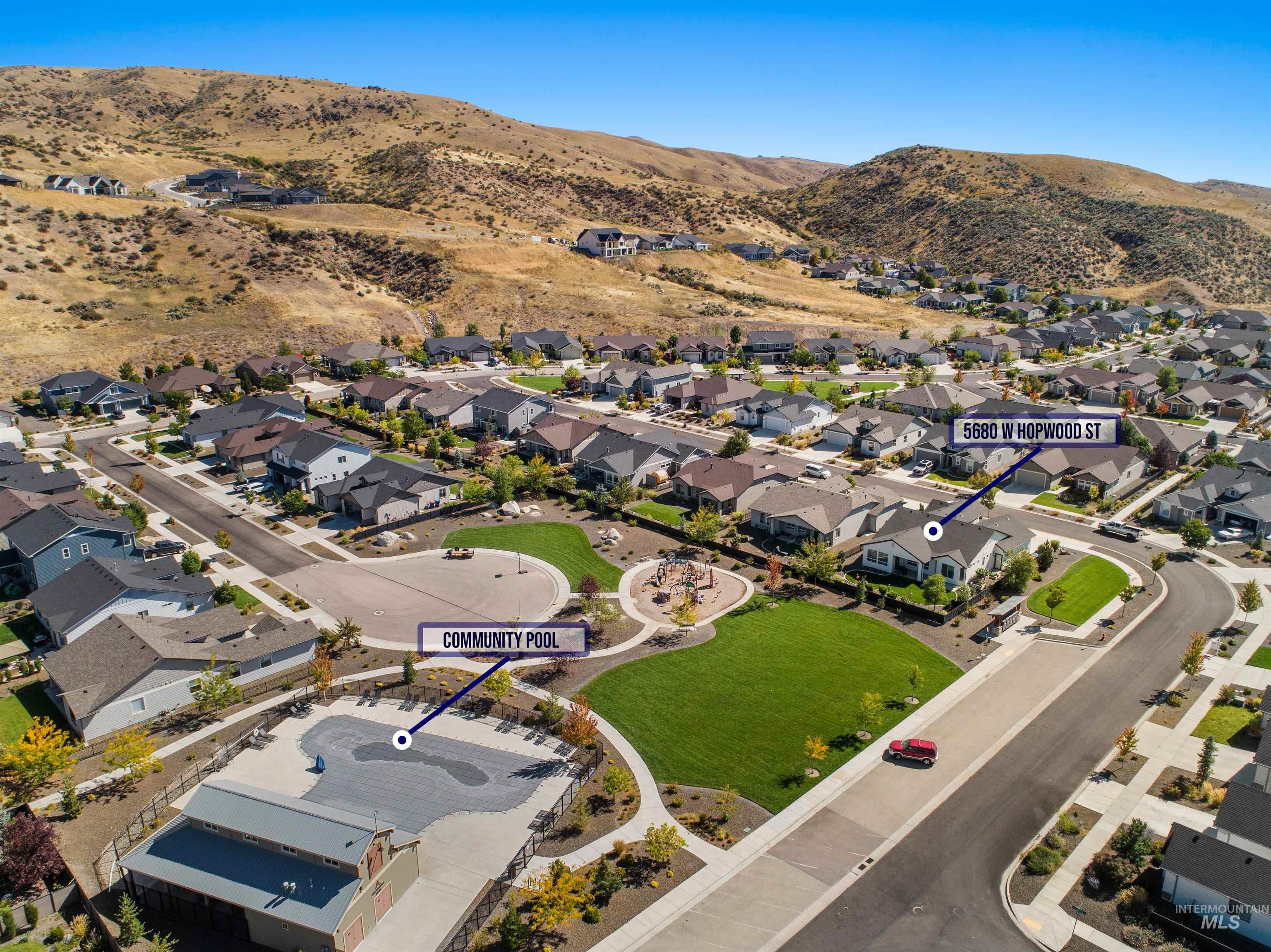 Aerial view of property's location with mountains and nearby suburban area