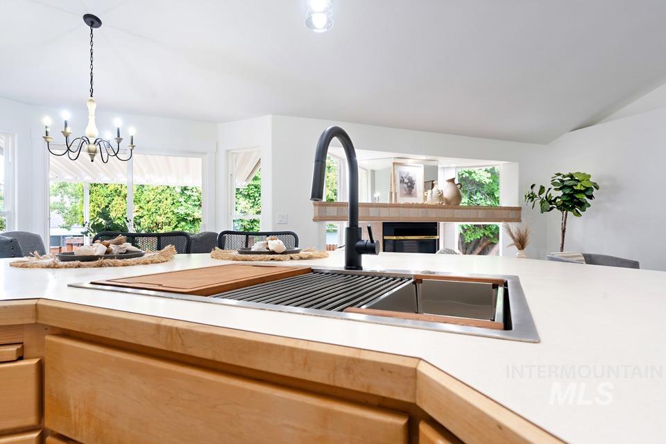 Kitchen with light countertops, open floor plan, and light brown cabinetry