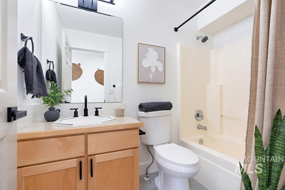 Full bathroom featuring shower / tub combo and vanity