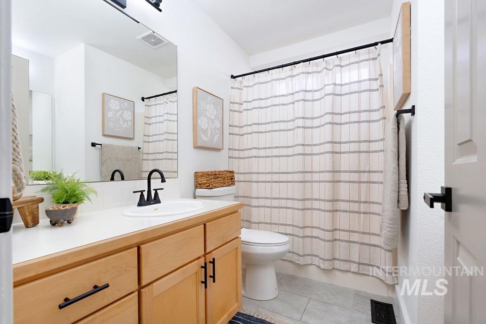 Bathroom featuring vanity and light tile patterned floors