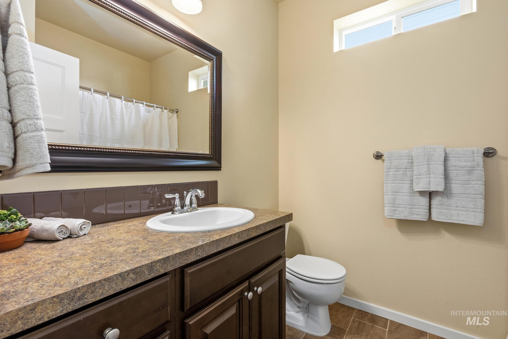 Full bathroom featuring vanity and a shower with shower curtain