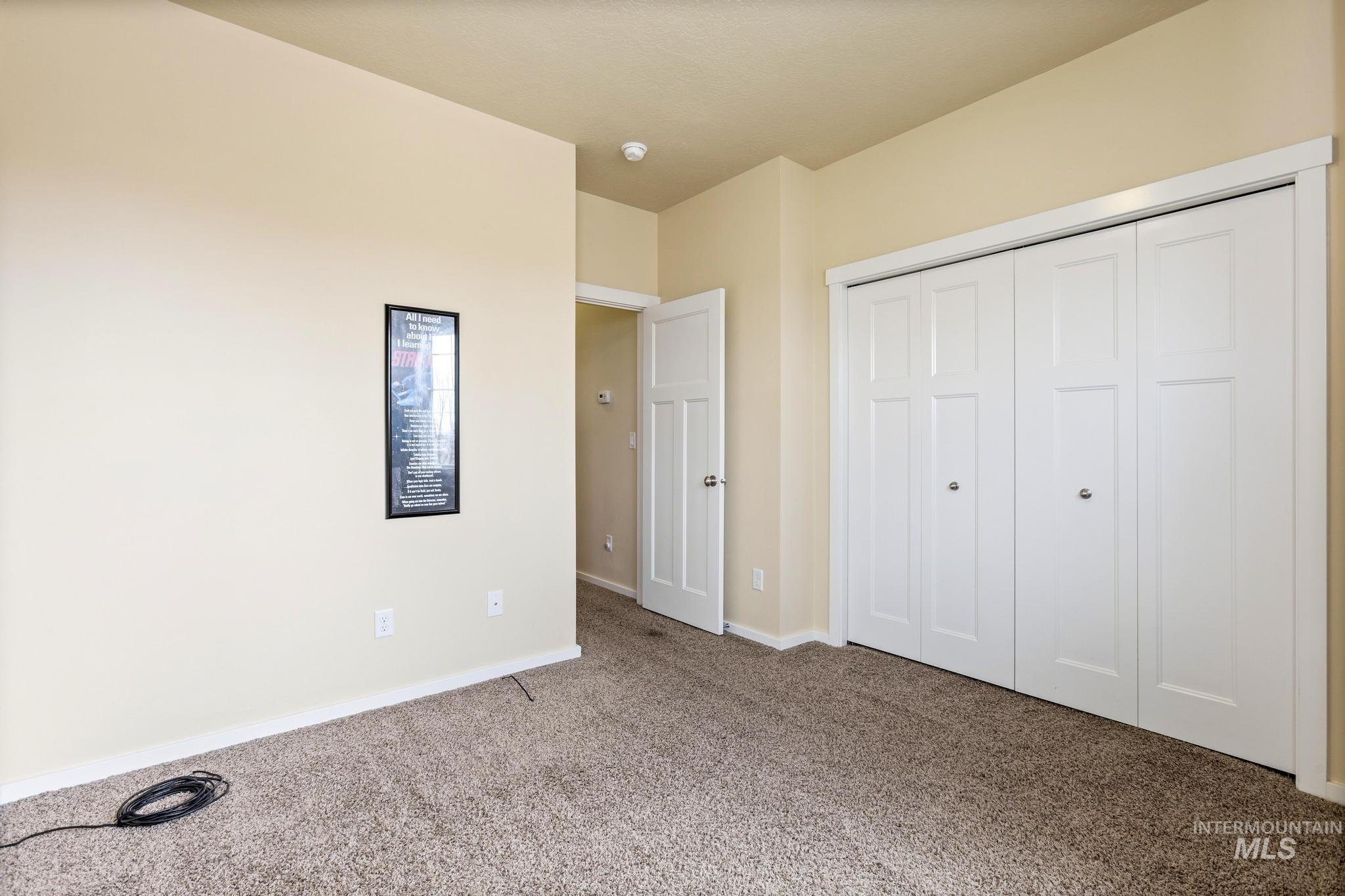 Unfurnished bedroom with carpet floors and a closet