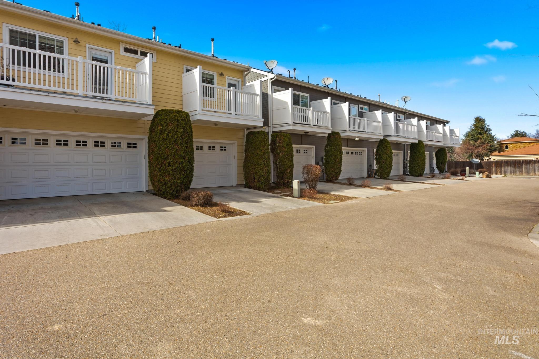 View of property featuring an attached garage and concrete driveway