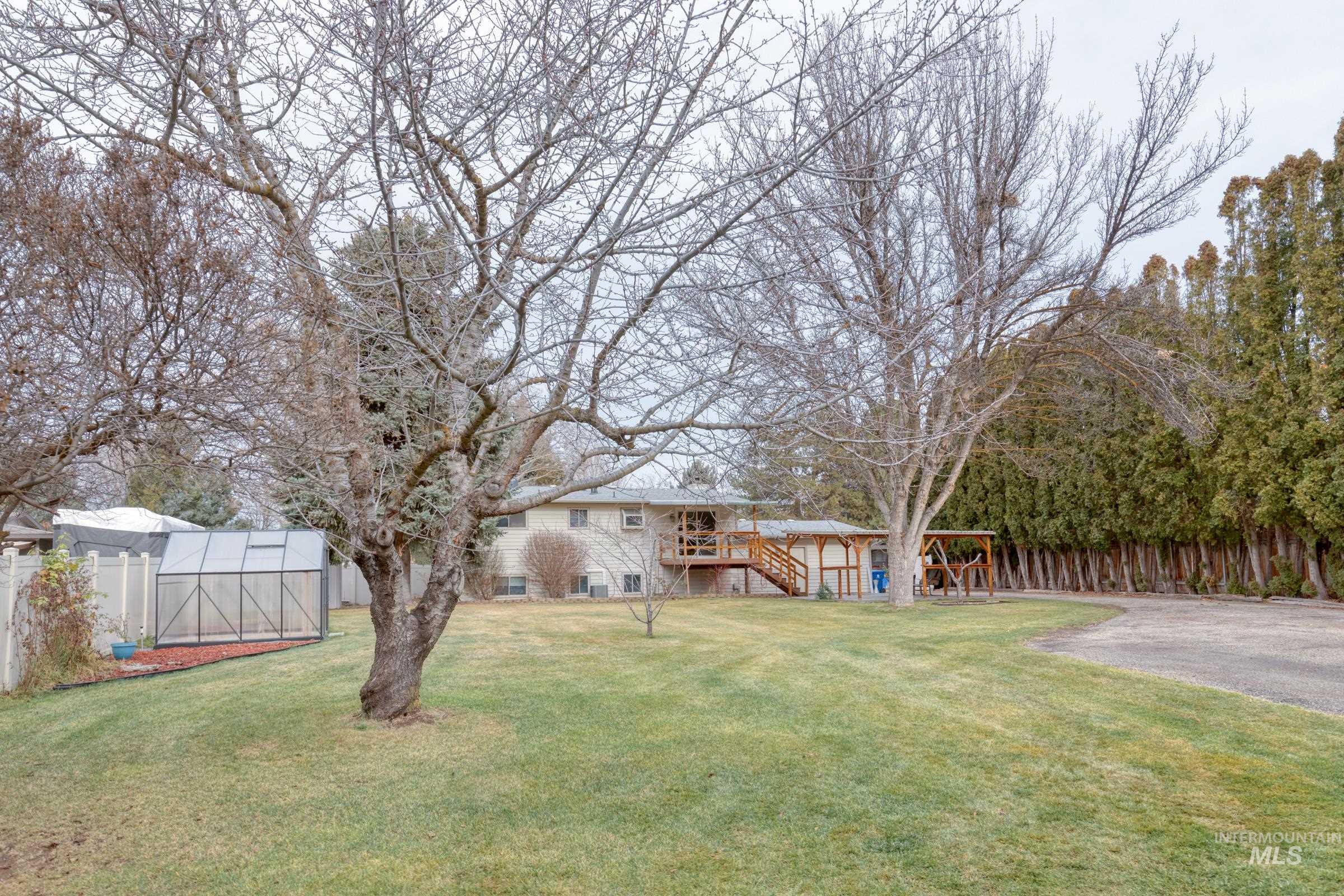 View of yard featuring a deck, stairs, an exterior structure, and an outdoor structure