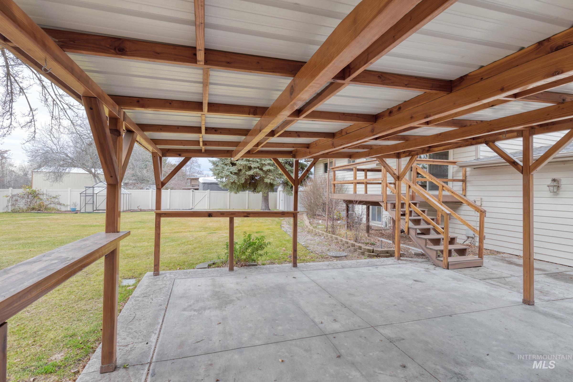 Fenced backyard featuring stairs and a patio area