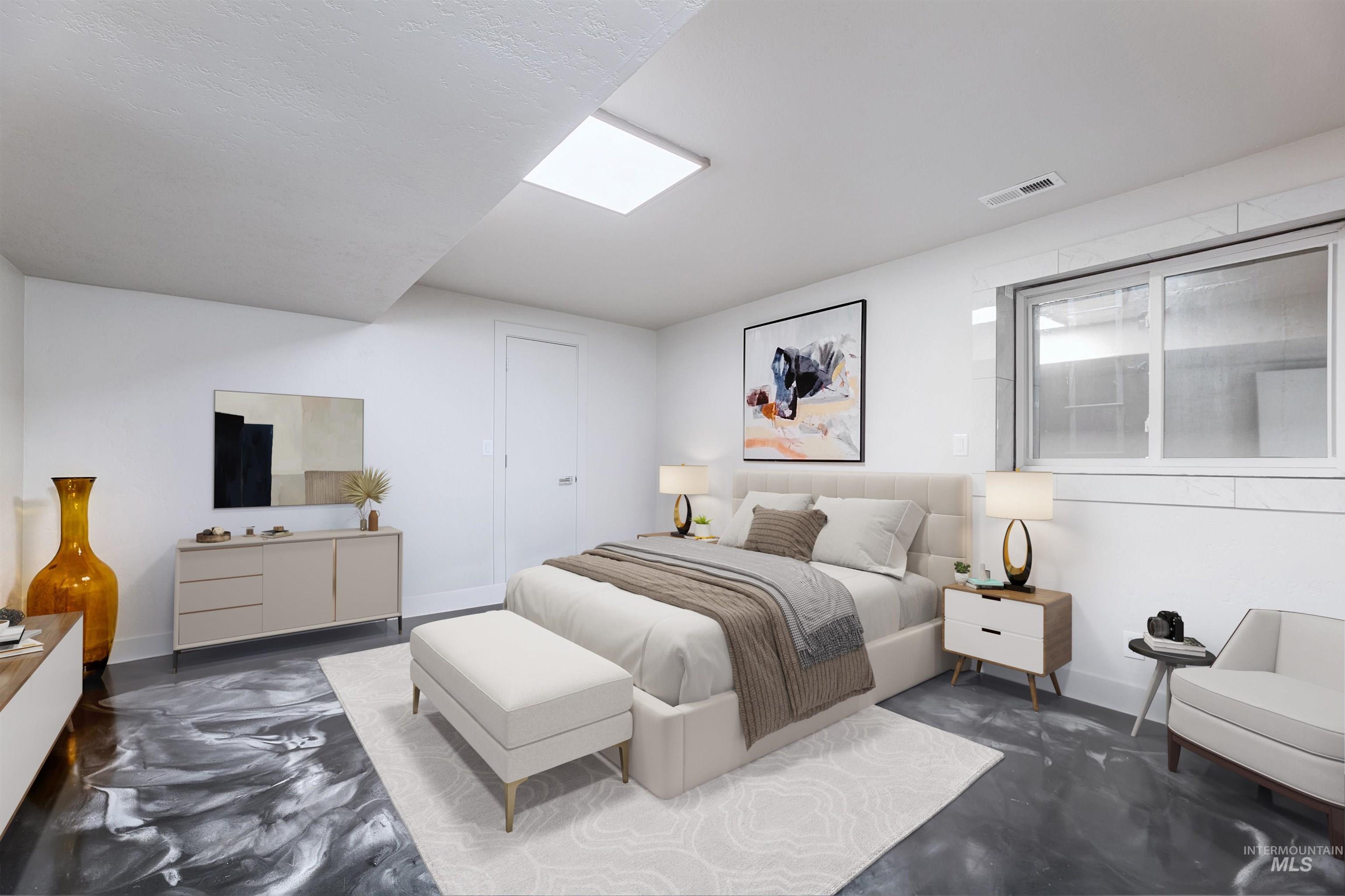 Bedroom featuring concrete flooring.