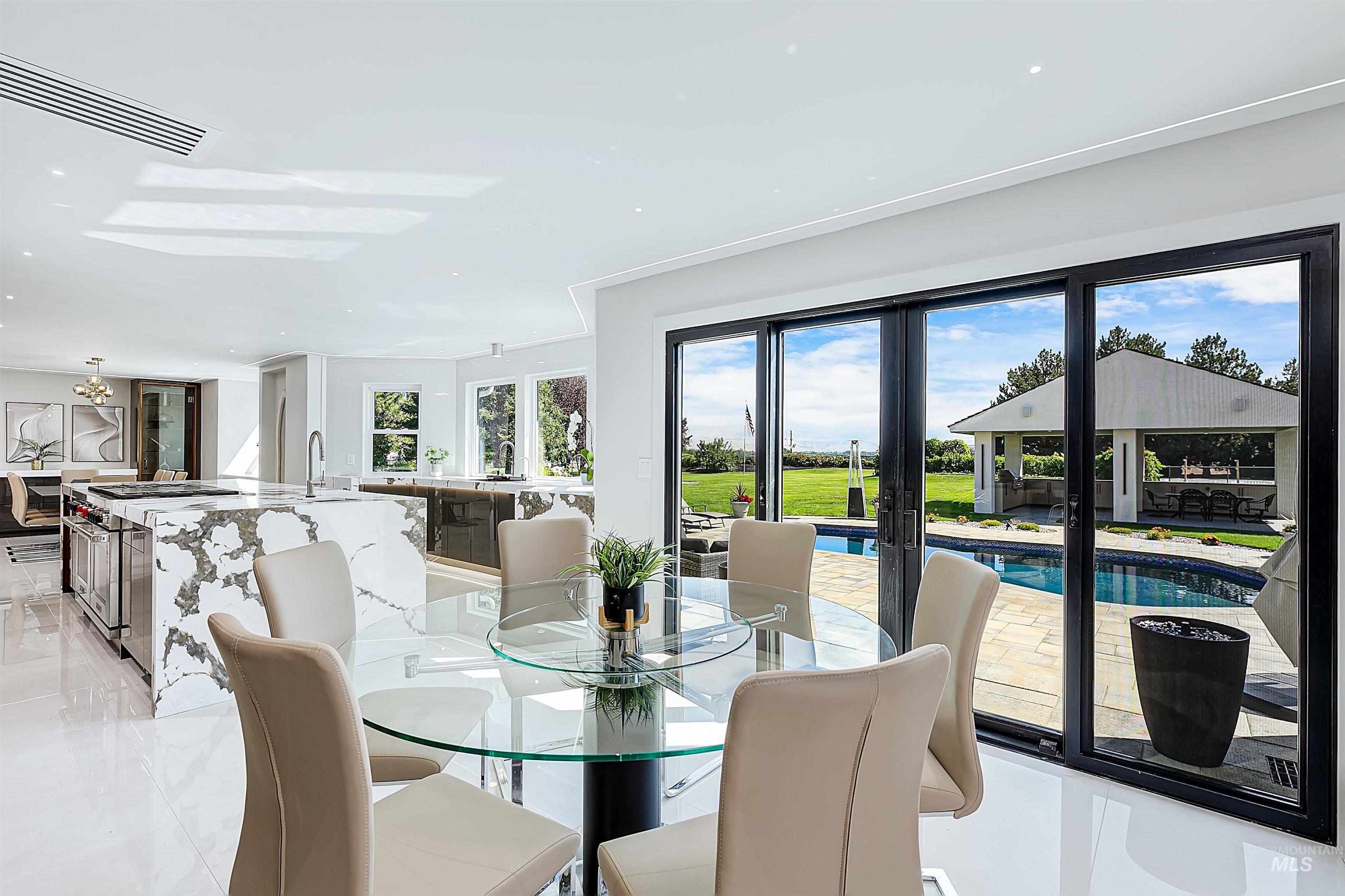 Informal dining room with french doors and recessed lighting.
